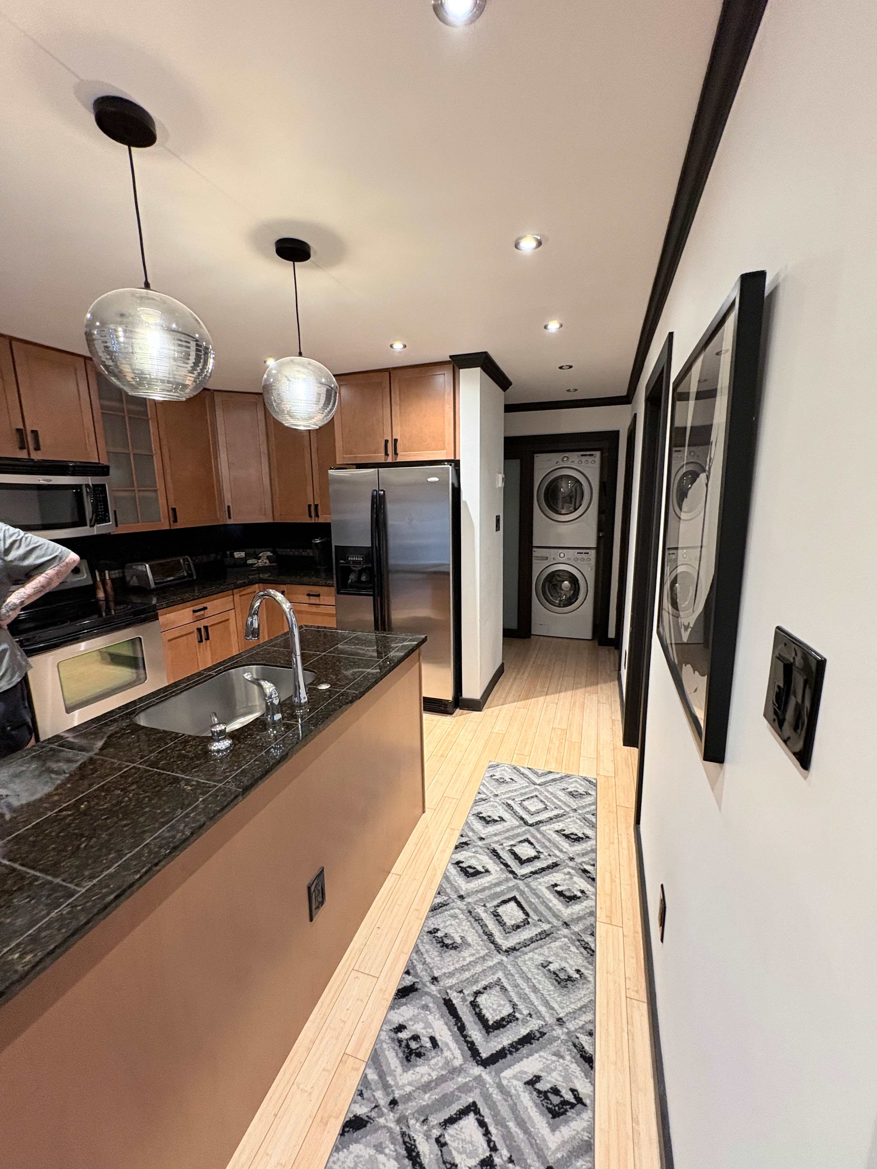 Sleek kitchen with modern amenities and in-unit laundry for your convenience.