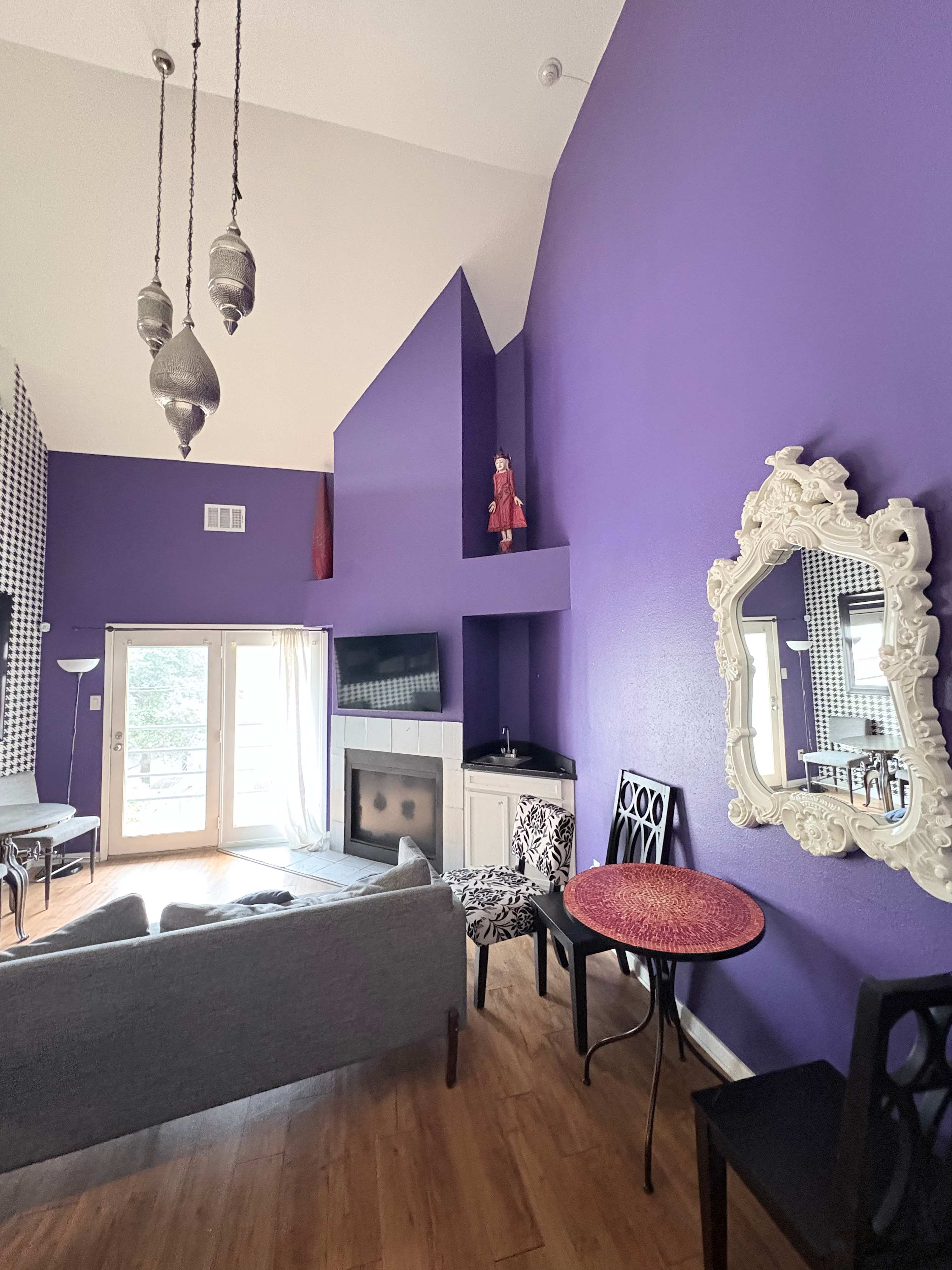 Stylish studio with vibrant decor, cozy seating, and a private balcony for a relaxing stay.