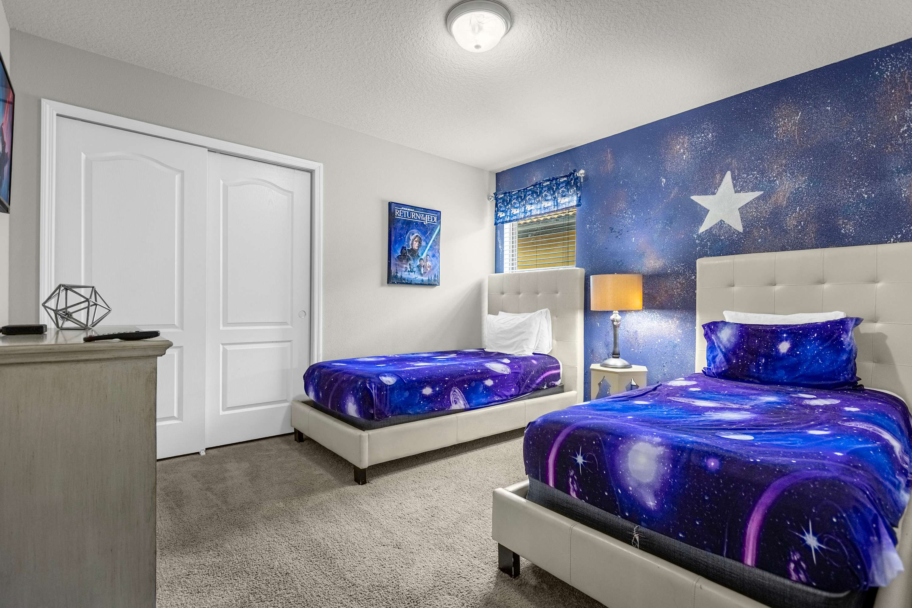 Explore the cosmos in this galaxy-themed bedroom, perfect for young adventurers seeking a stellar sleep experience.