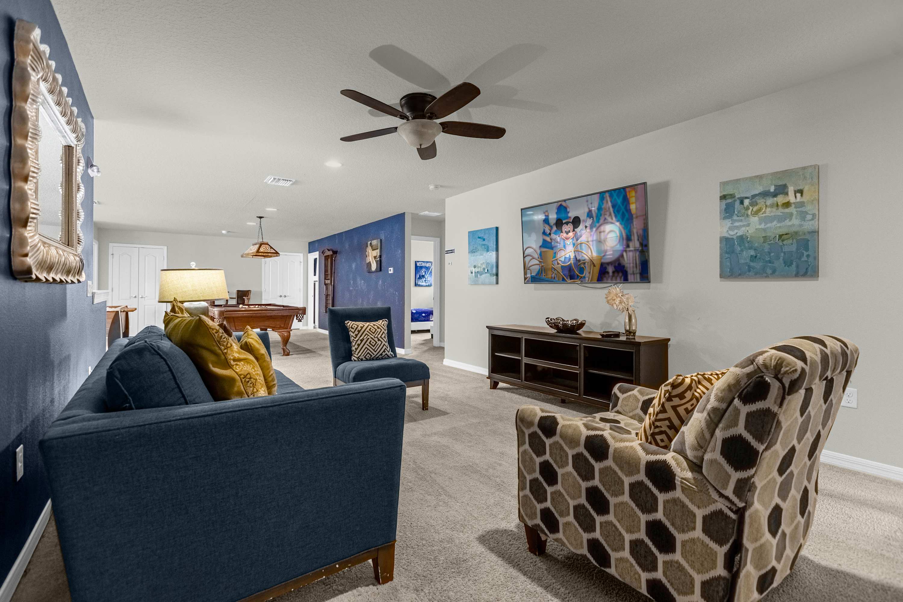 Stylish game room with pool table and large TV, perfect for family fun and relaxation.