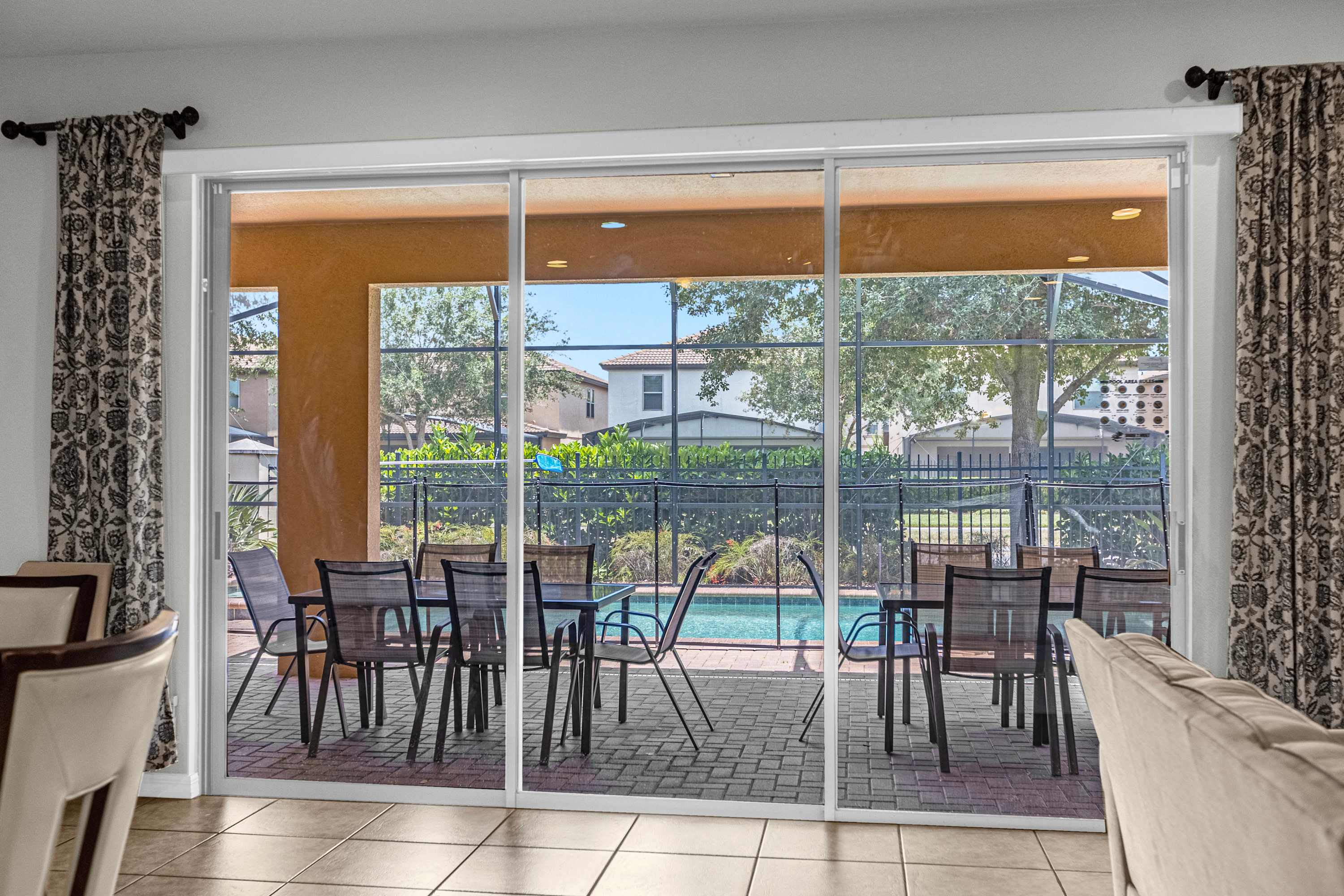 Enjoy the expansive patio with ample seating and pool views, ideal for relaxing or entertaining.