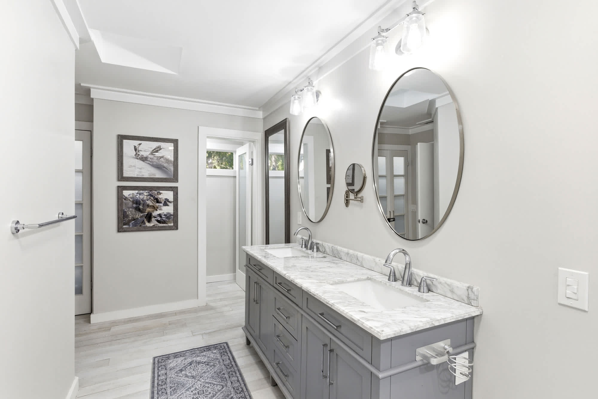 The full primary bath reveals generous counter space, dedicated storage, a water closet, and all the upscale finishes you'd expect from a boutique hotel suite.