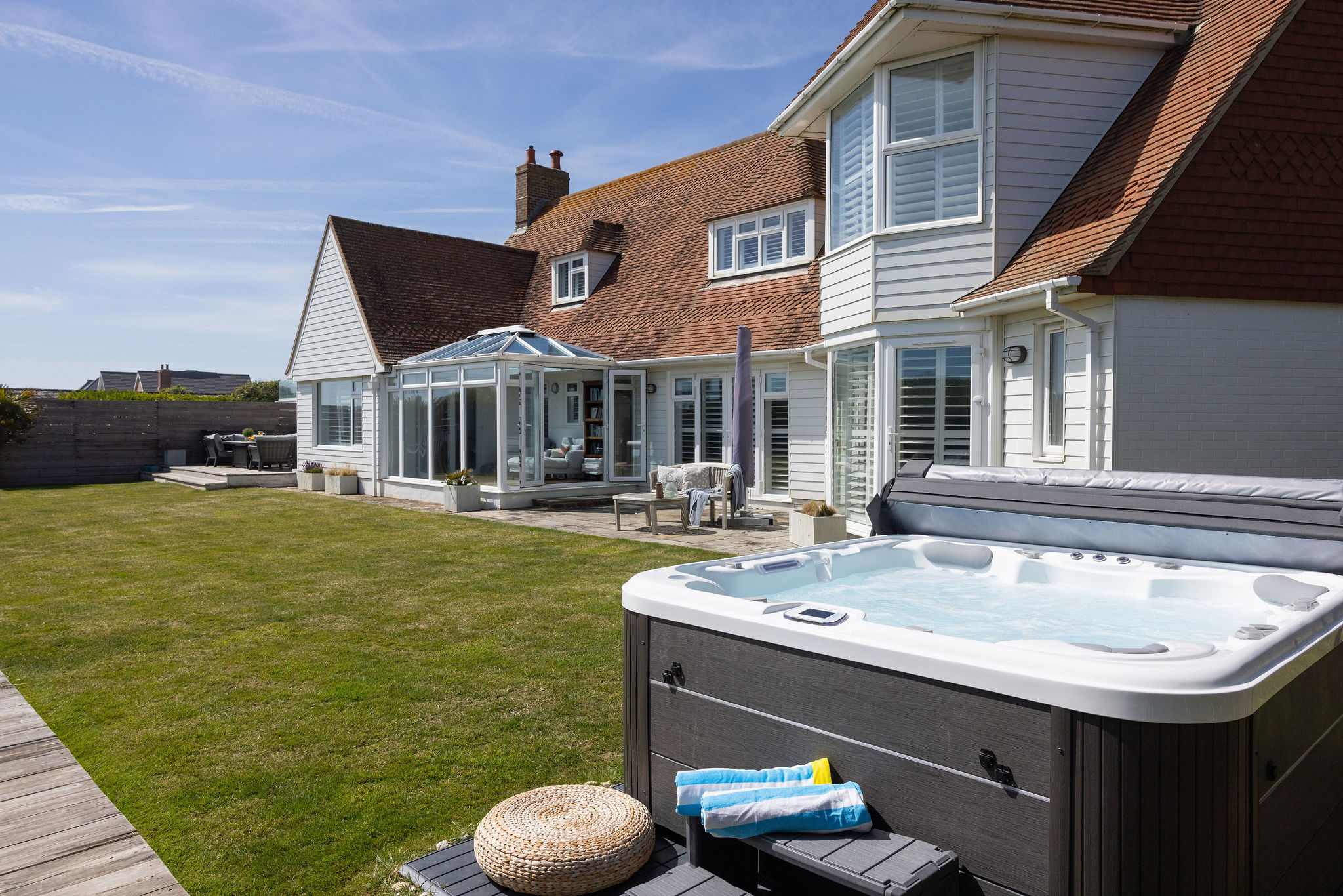 Seafront garden with hot tub & sun deck.