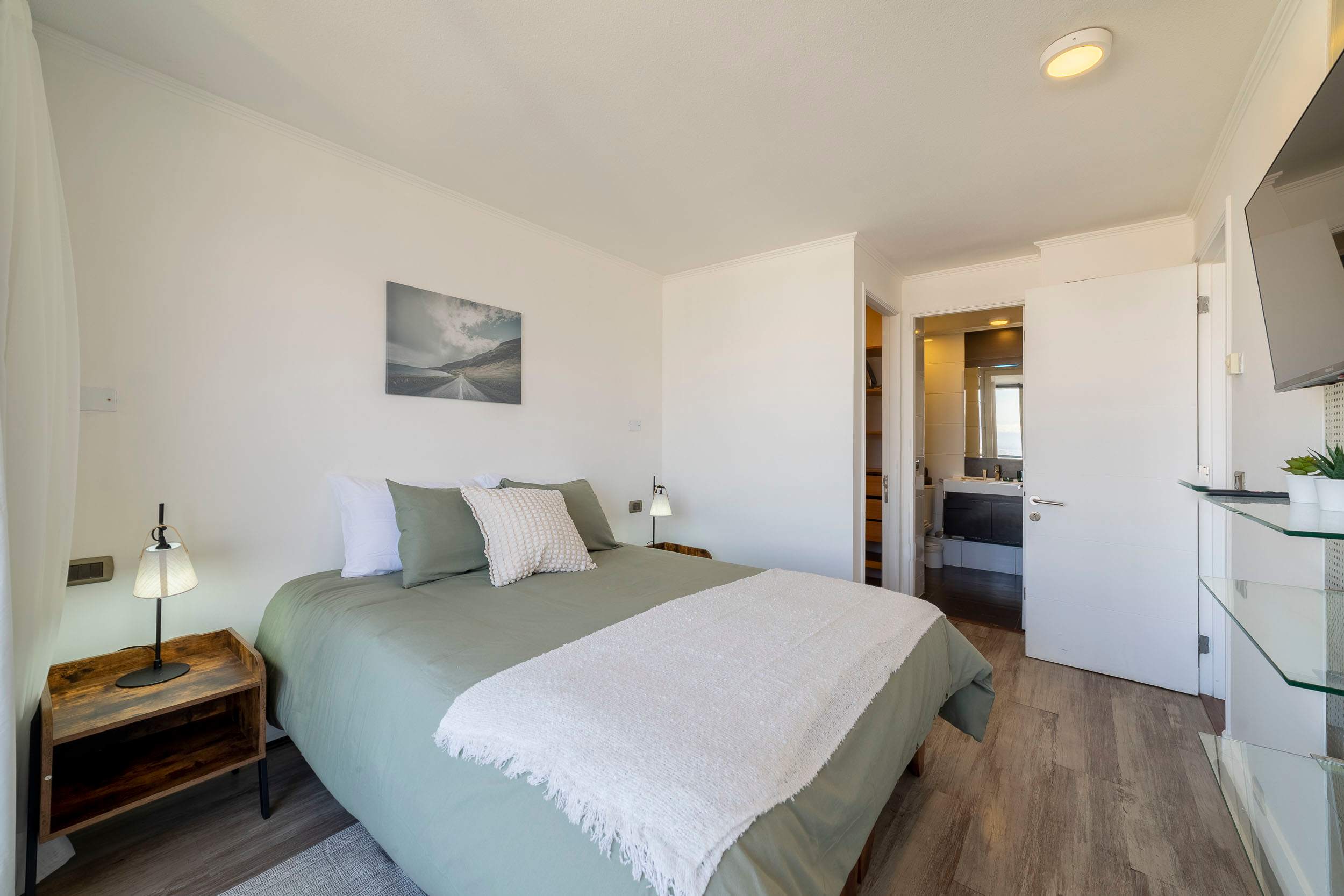 Relax in this cozy bedroom with modern amenities and a serene atmosphere, perfect for unwinding after a day of exploring.