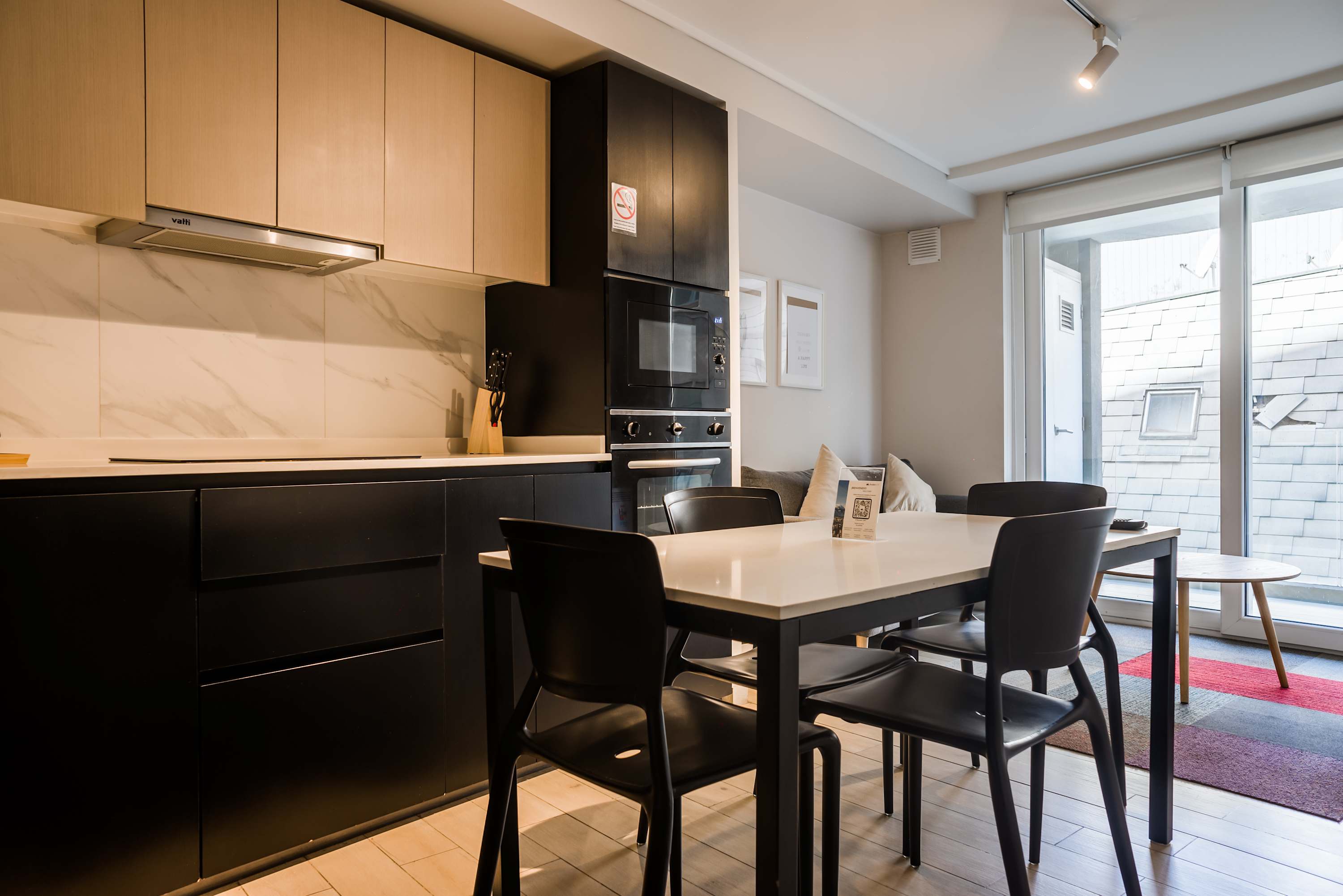Modern kitchen with sleek design and ample natural light, perfect for intimate dining and relaxation.