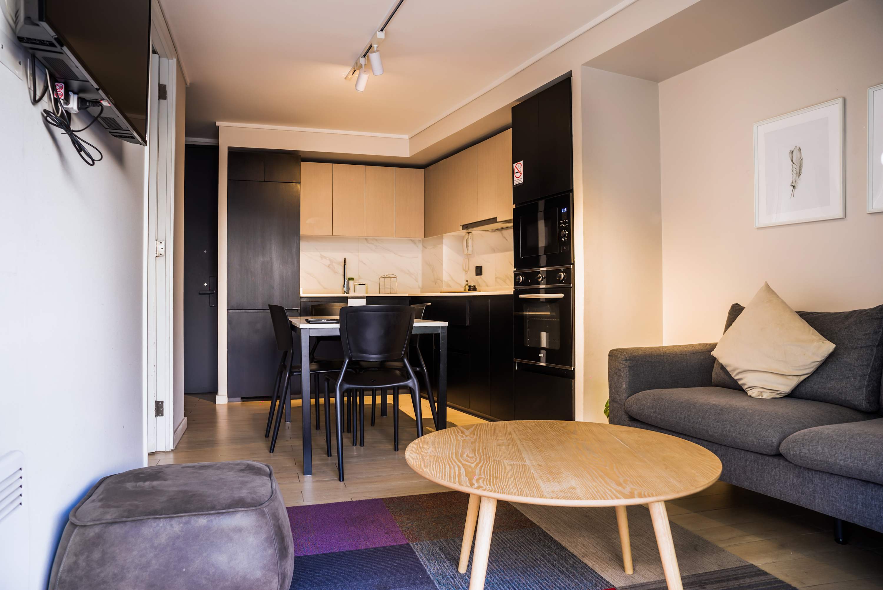 Modern studio with sleek kitchen and cozy living space, perfect for a city getaway.