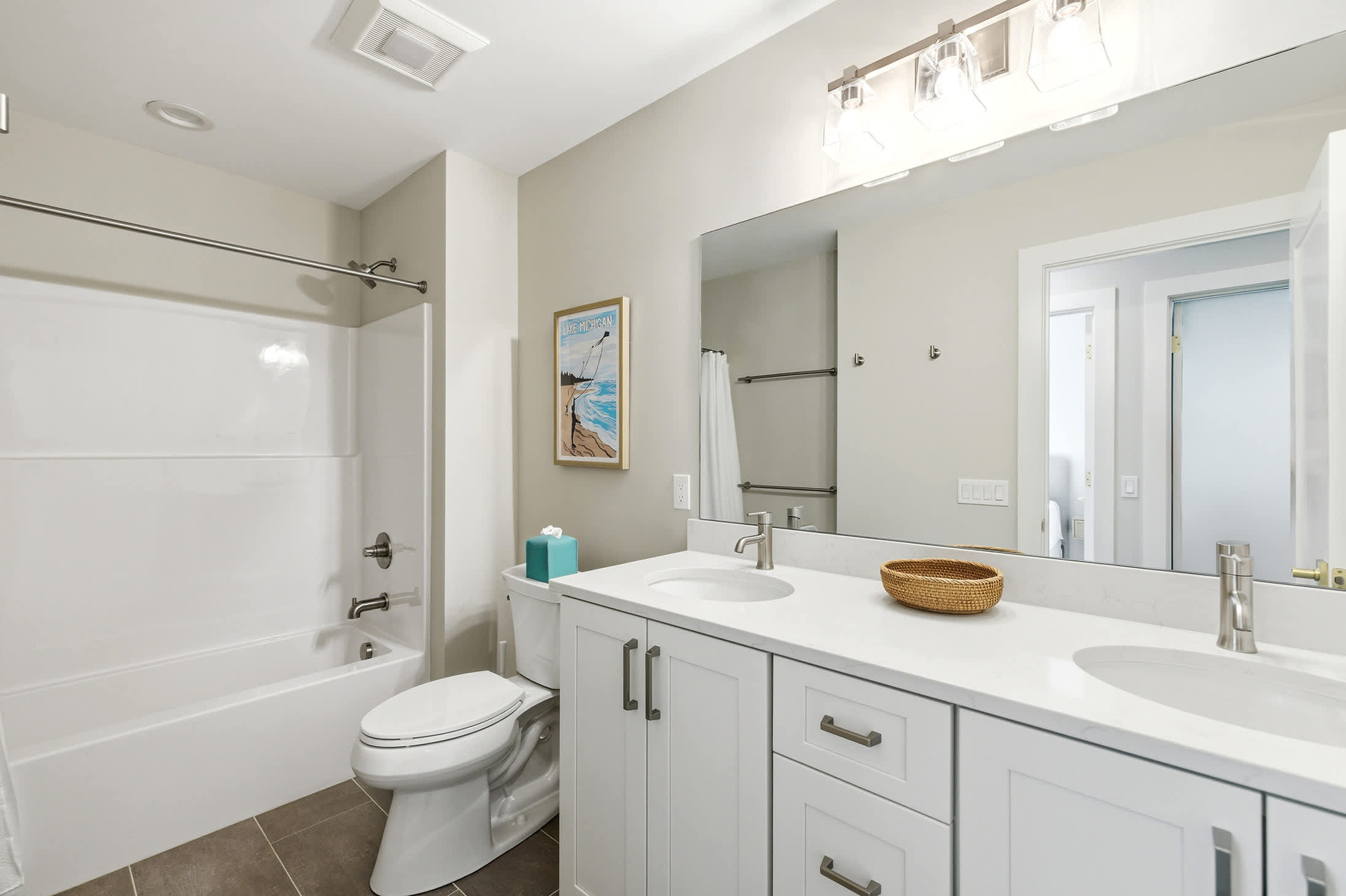 Third floor shared bath with double vanity for easier mornings.