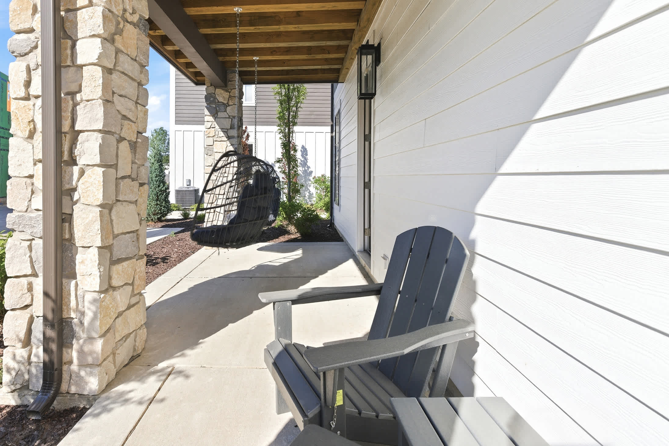 Covered porch seating adds extra space to gather and unwind.