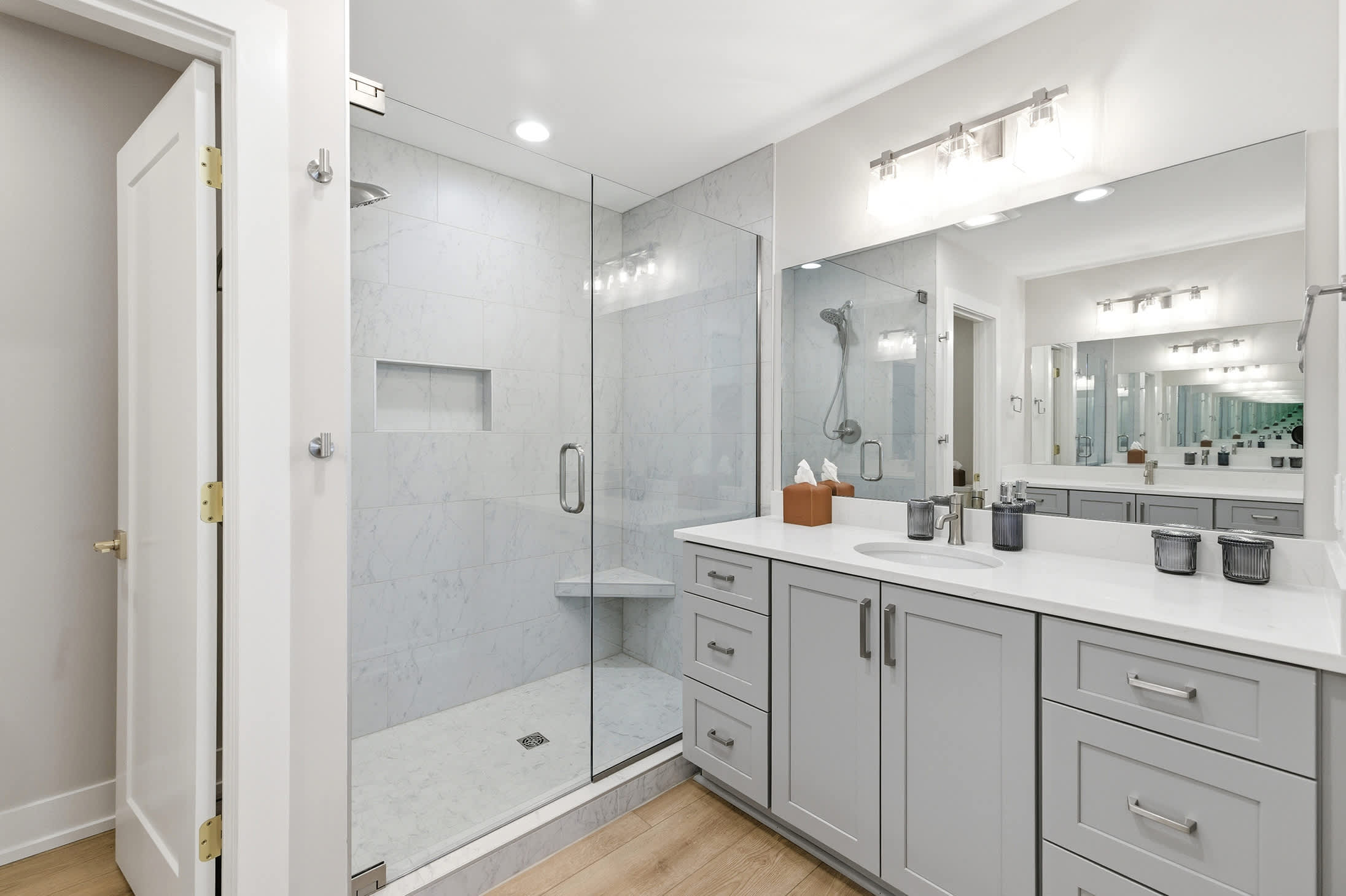 Walk-in marble shower, double sinks, and serious spa-day energy.