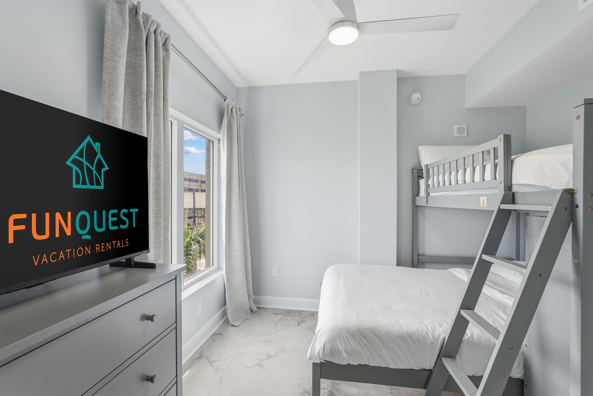 Tidewater 200 – Bedroom with a TV, bunk bed, and a window view.
