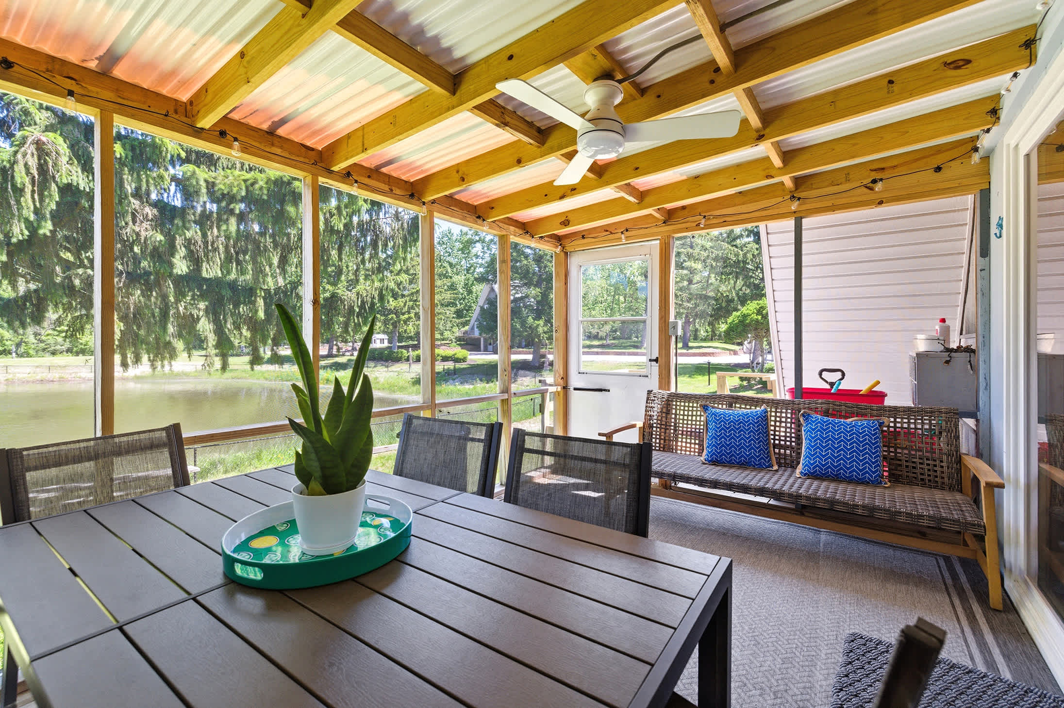 Private screened porch overlooking the pond, adding room to relax outdoors.