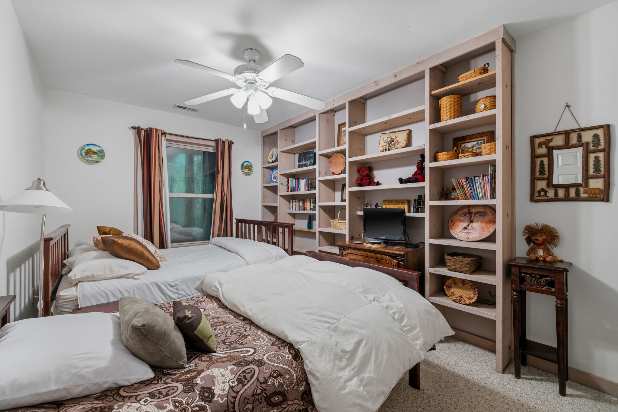 A flexible room ideal for kids, teens, or small families featuring a full bed and twin bed and Smart TV located near shared bathroom