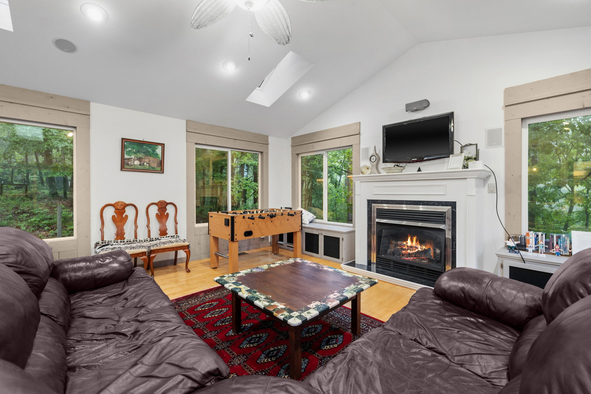 Spacious family room with fireplace, surround sound, a custom bar and a wine chiller