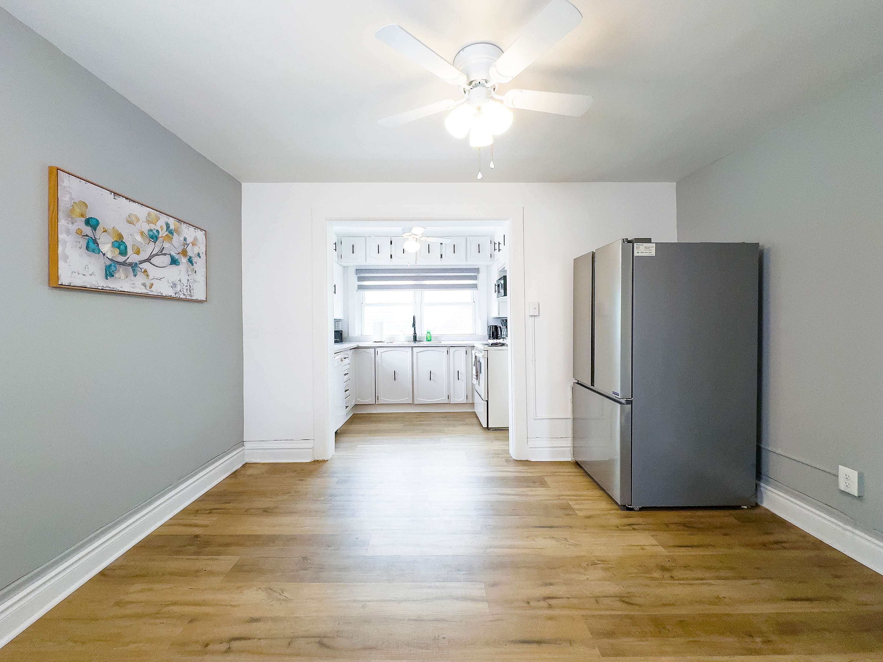 A Bright And Spacious Dining Area Leading Into A Modern Kitchen