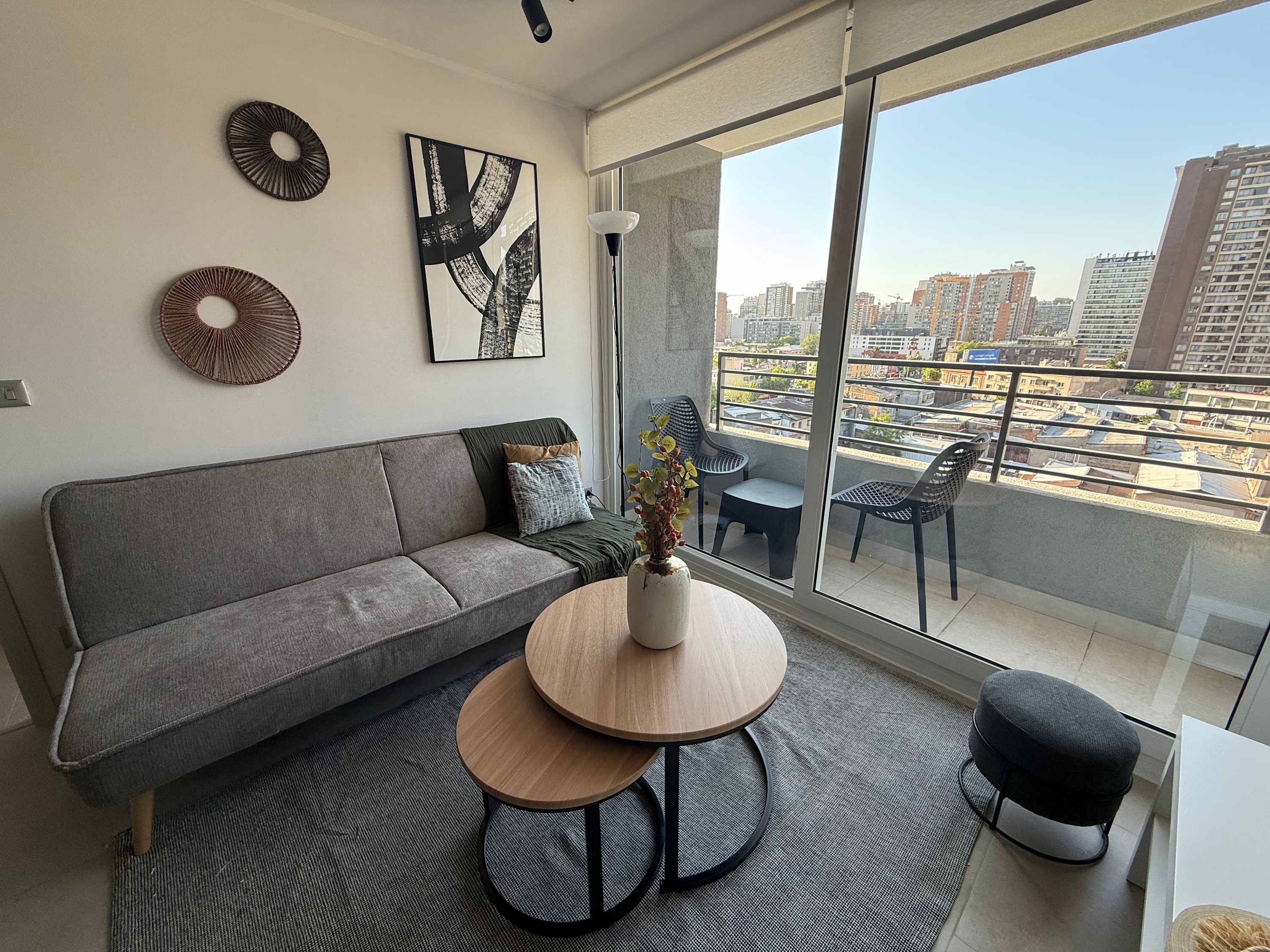 Relax in this cozy living room with stunning city views from the balcony, perfect for unwinding after a day of exploring.