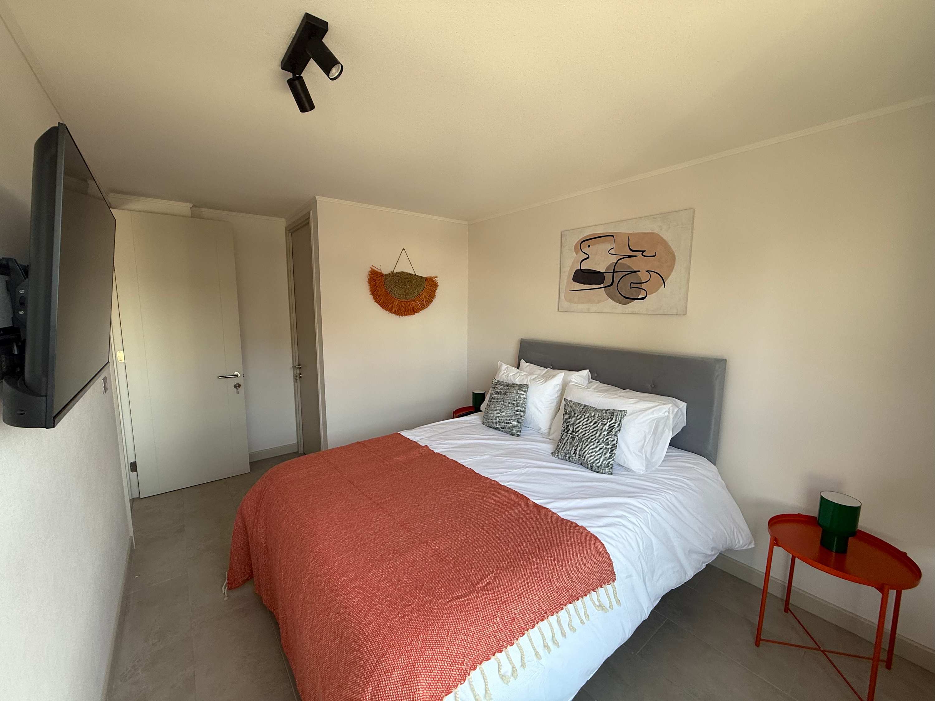 Relax in this stylish bedroom with modern decor and cozy bedding, perfect for unwinding after a day of exploring.