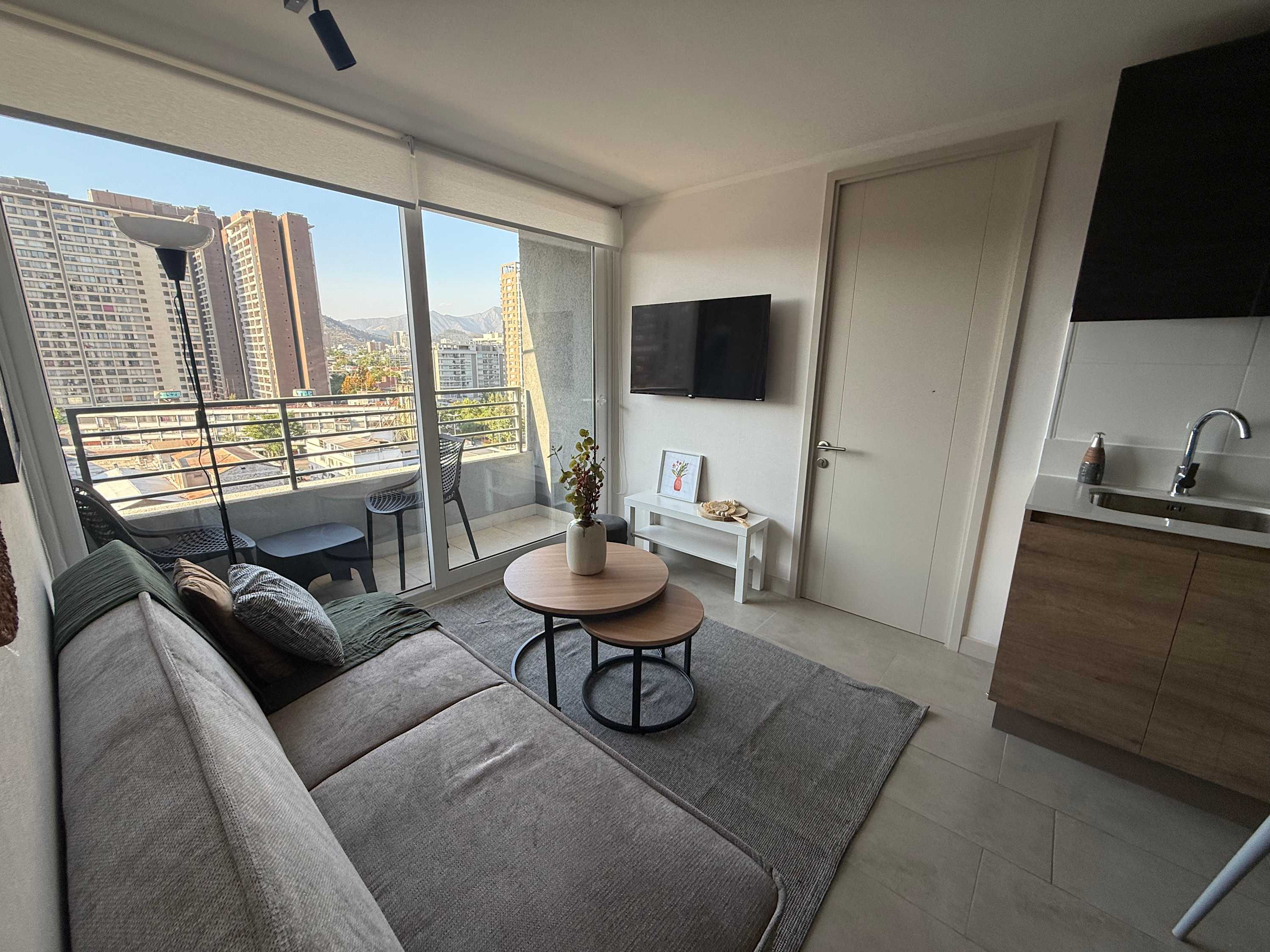 Enjoy stunning city views from this cozy living room with modern amenities and a sleek design.