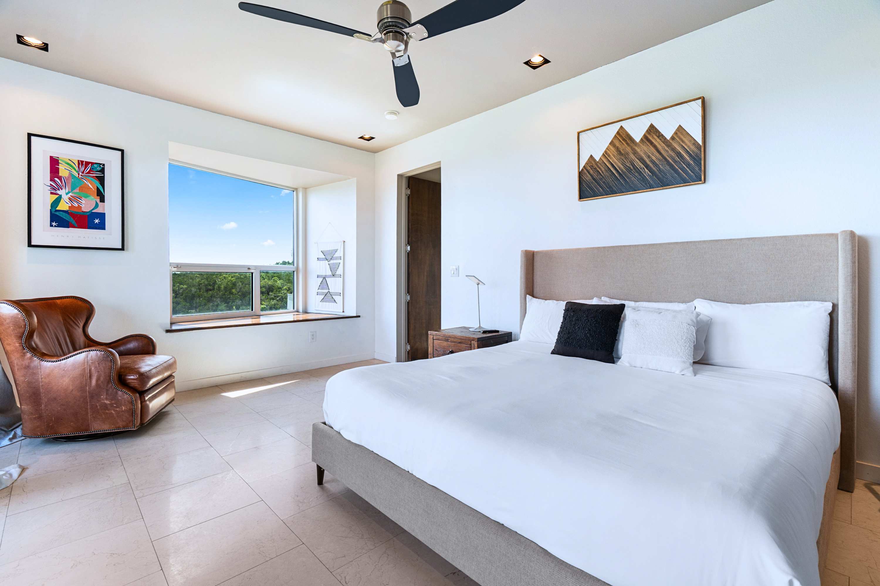 Relax on your King-sized bed with plush bedding and fresh linens for a comfortable stay.