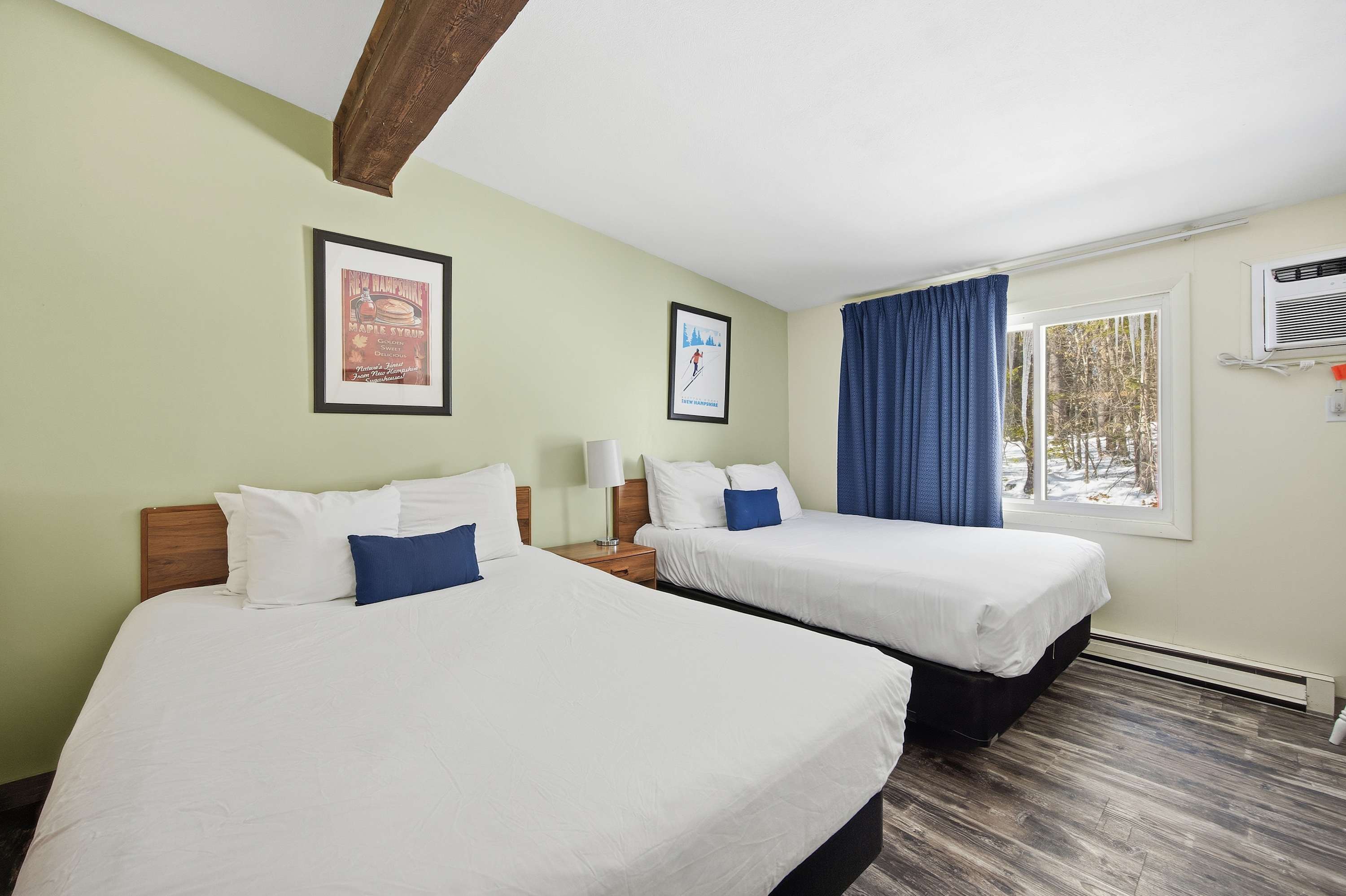 The bedroom retreat offers a pair of plush queen beds & a TV​