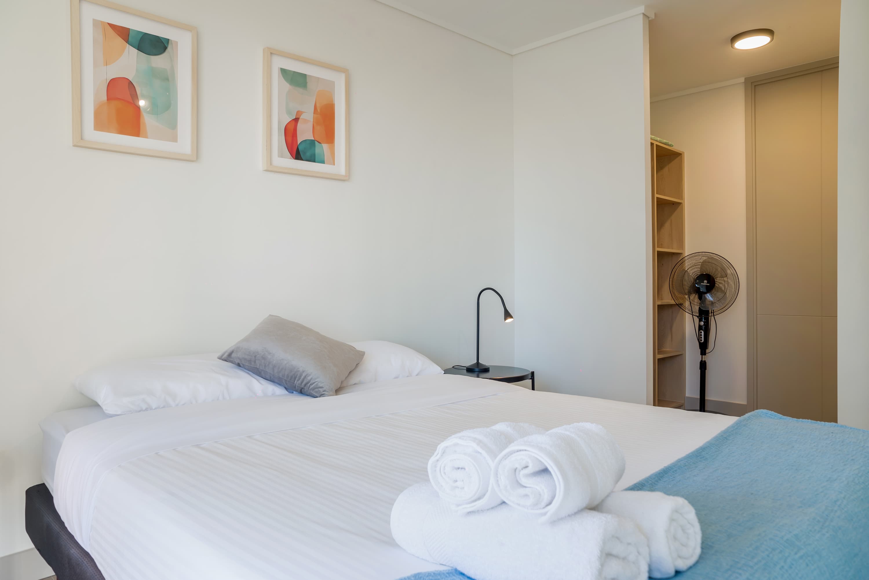 Relax in this cozy bedroom with modern decor and soft lighting, perfect for a restful stay.
