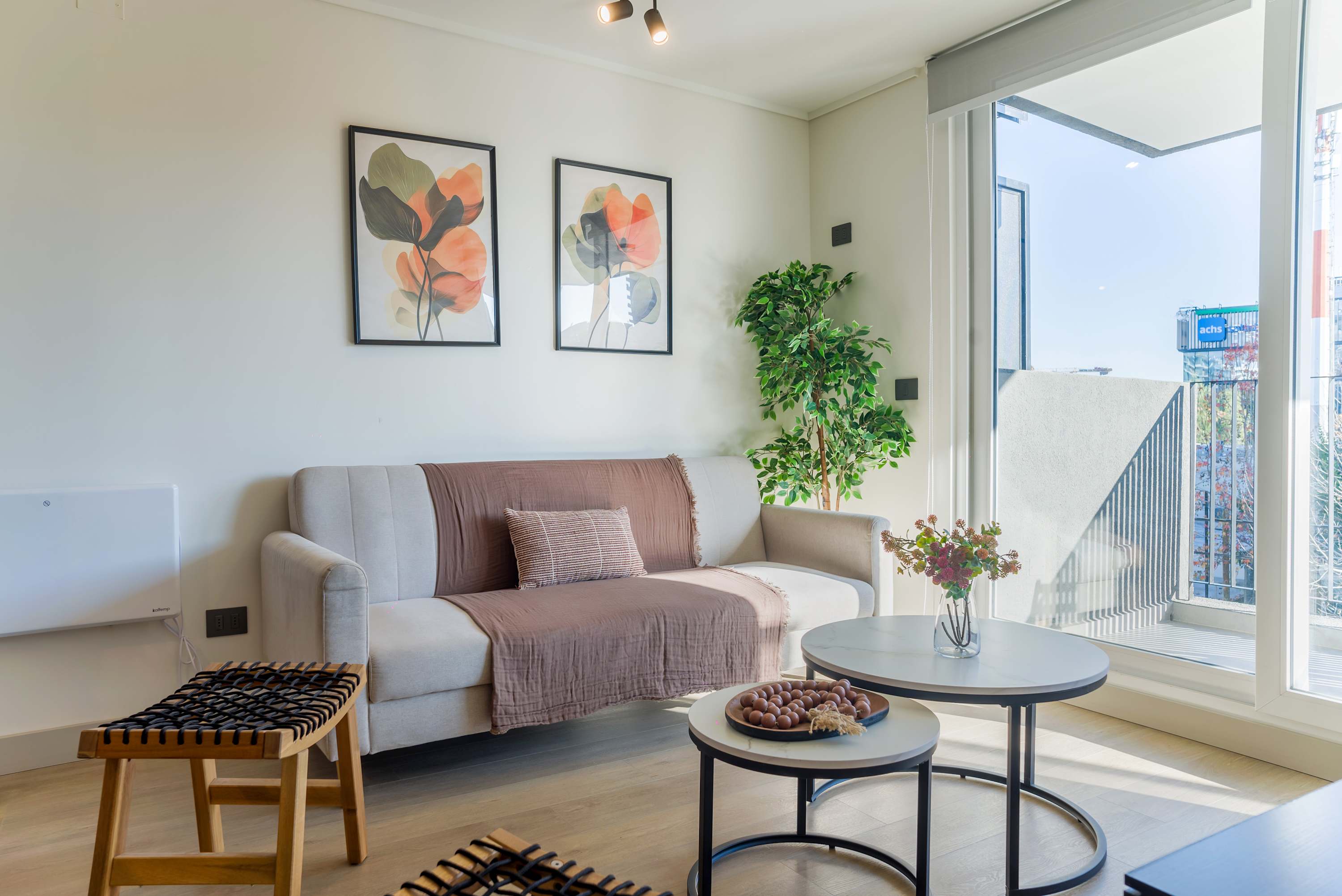 Bright and inviting living area with stylish decor and balcony access, perfect for relaxation.