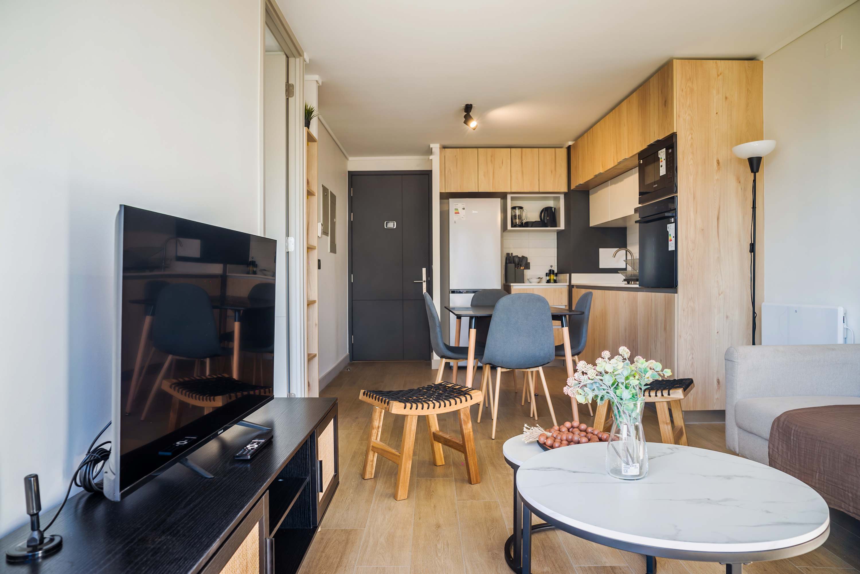 Cozy and modern living area with a sleek kitchen, perfect for relaxing after exploring the city.