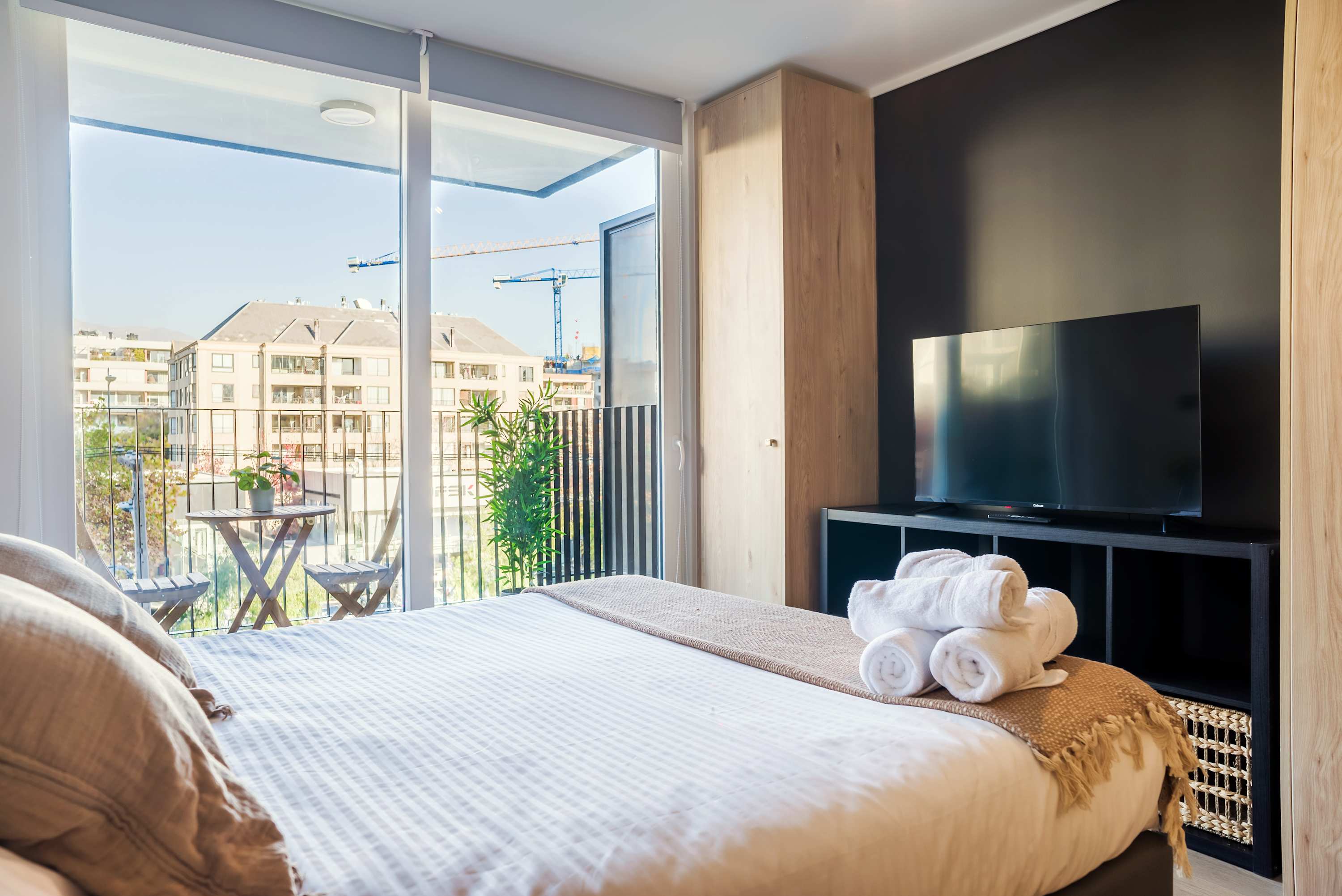 Relax in this cozy bedroom with a private balcony offering city views, perfect for unwinding after a day of exploring.