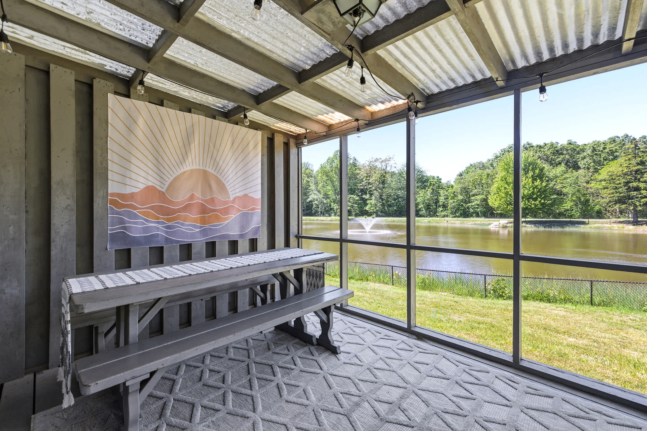 Outdoor seating area with scenic pond and fountain views.