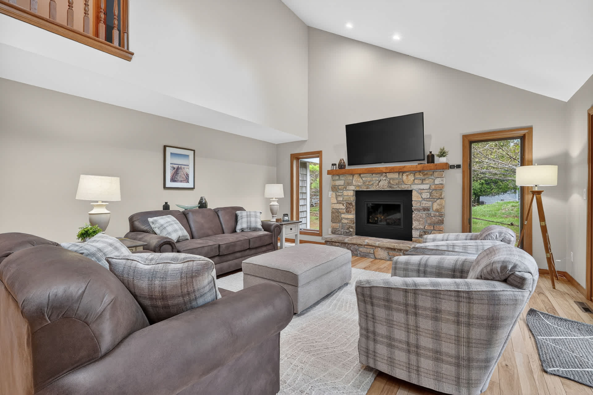 Sink into plush seating by the stone fireplace, gather your group for a cozy movie night, and enjoy the natural light streaming through the windows as you make this airy living room your home base.