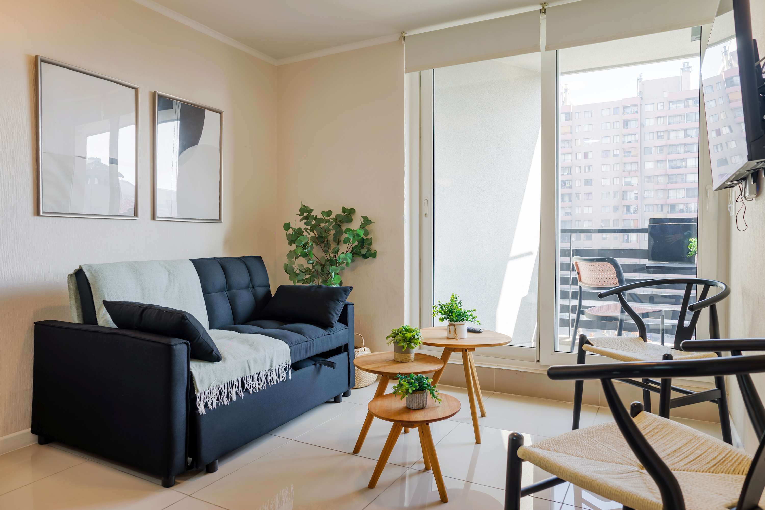 Relax in this cozy living space with a balcony view, perfect for unwinding after a day of exploring the city.