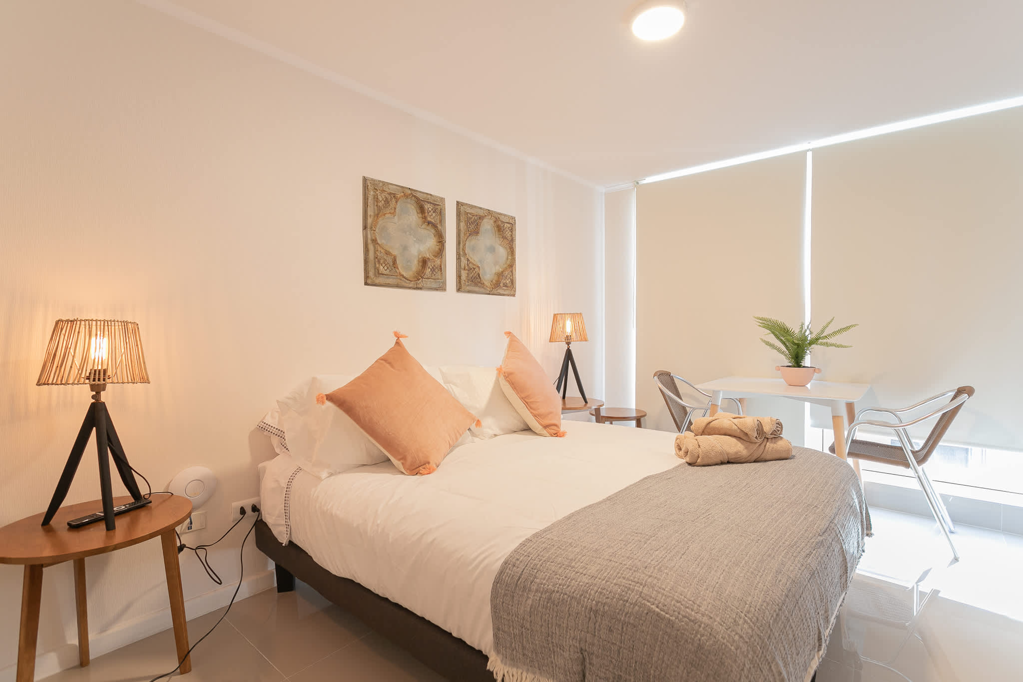 Relax in a cozy studio with chic decor and a bright dining nook, perfect for a comfortable stay.
