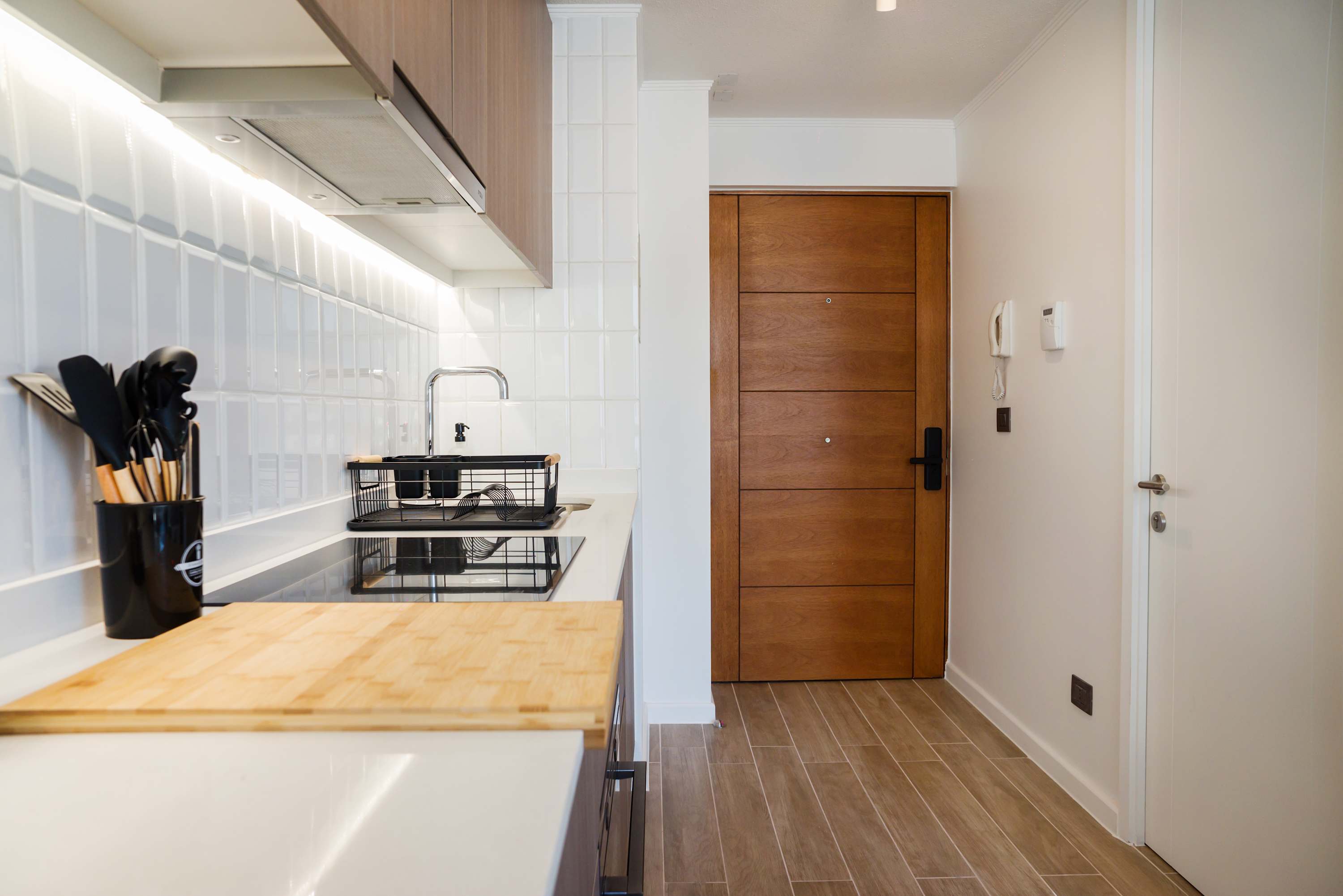 Modern and efficient kitchen with sleek appliances and stylish wood accents, perfect for cozy home-cooked meals.