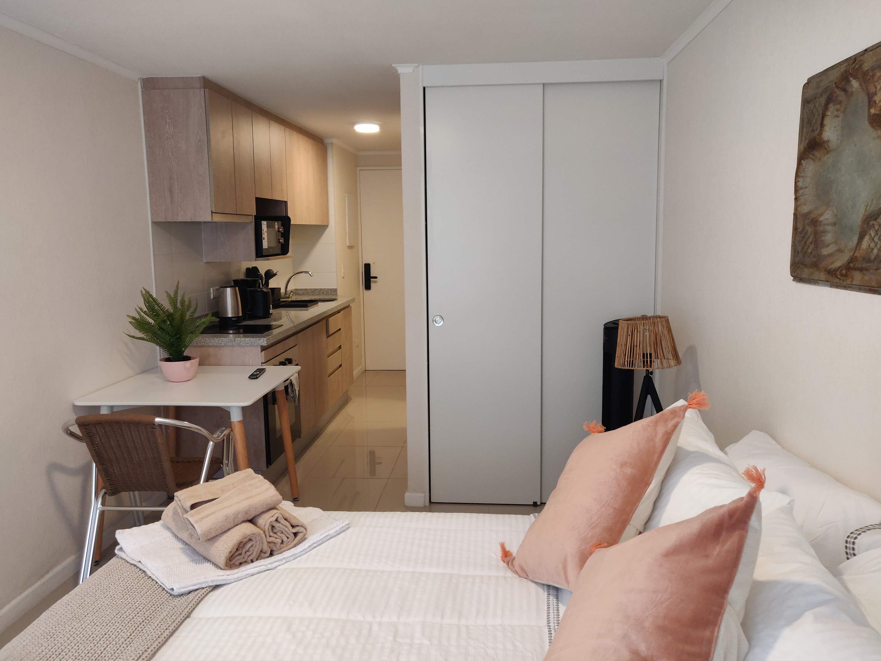 Cozy studio with modern kitchenette and stylish decor, perfect for a comfortable stay in the heart of the city.