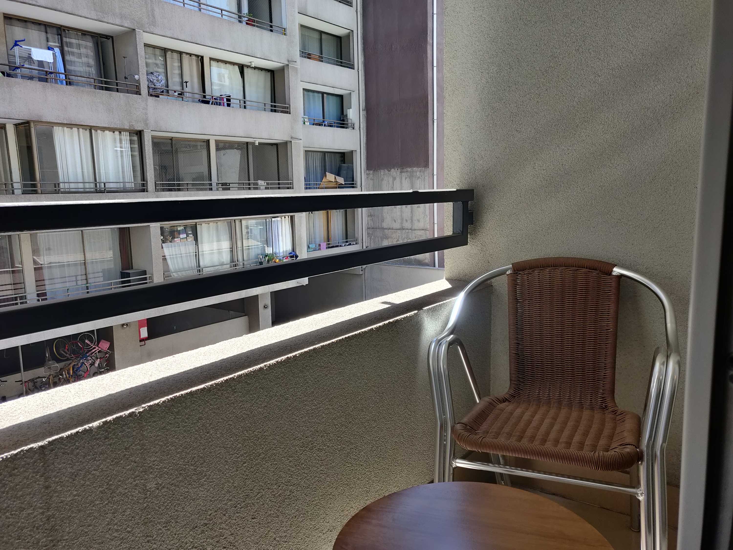 Cozy private balcony perfect for enjoying a morning coffee with a view of the cityscape.