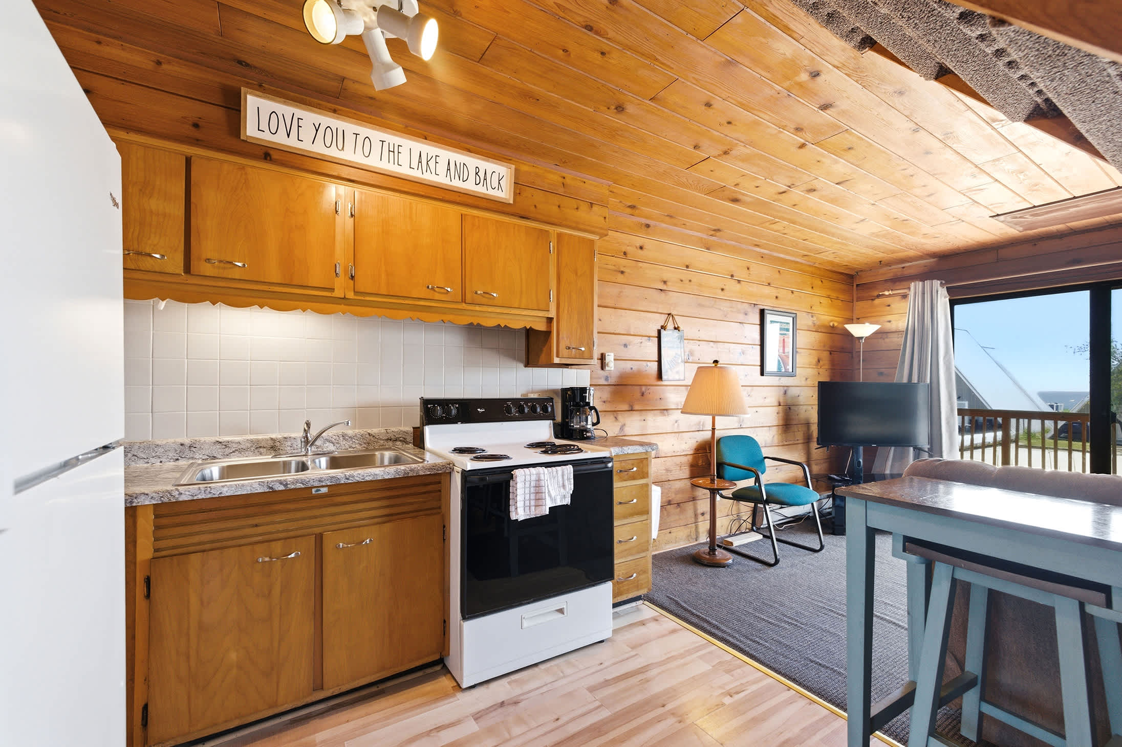 Steps from the deck, a full kitchen keeps meals and snacks convenient.
