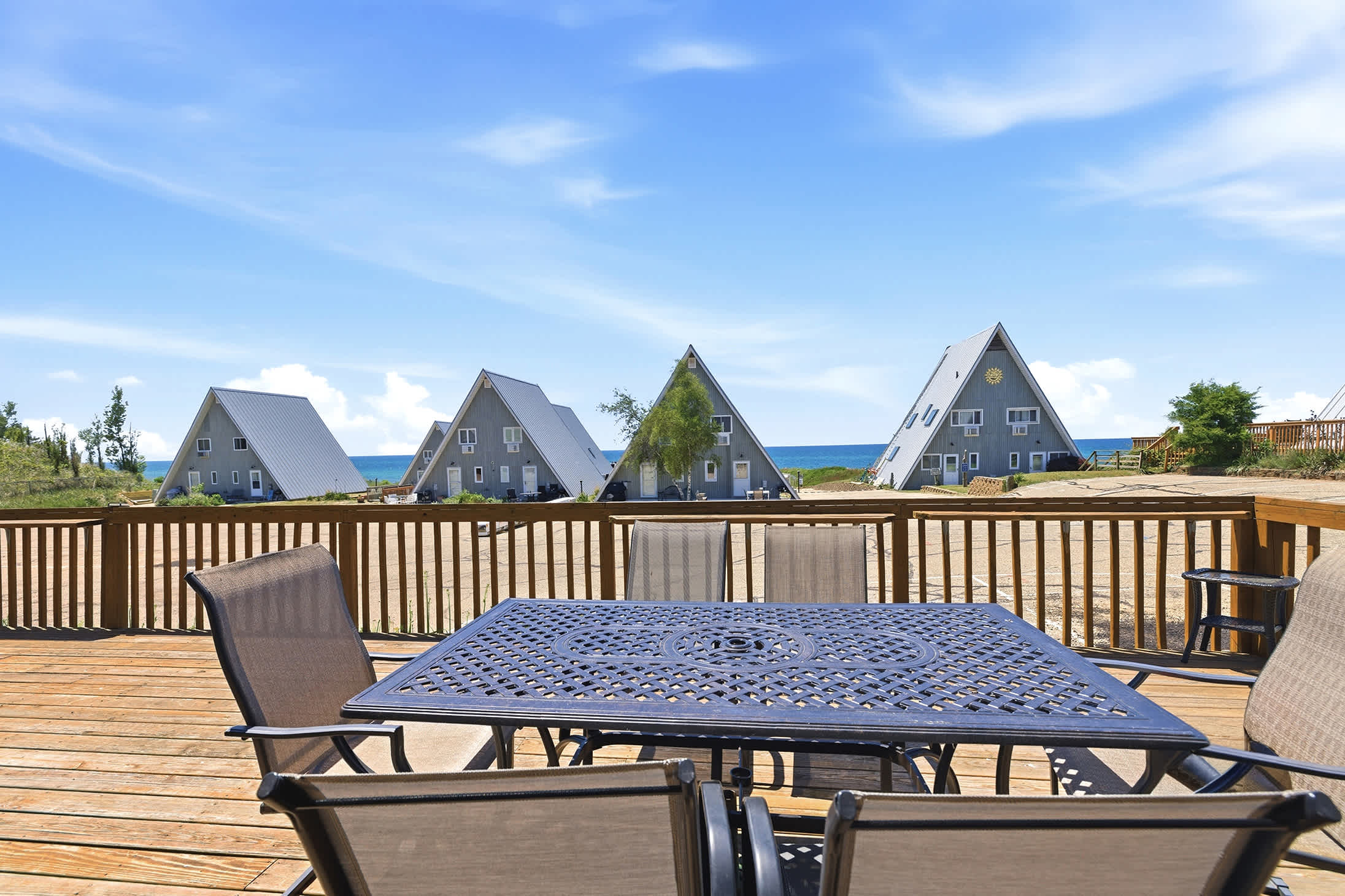 Deck dining table offers comfortable outdoor seating between beach and pool visits.