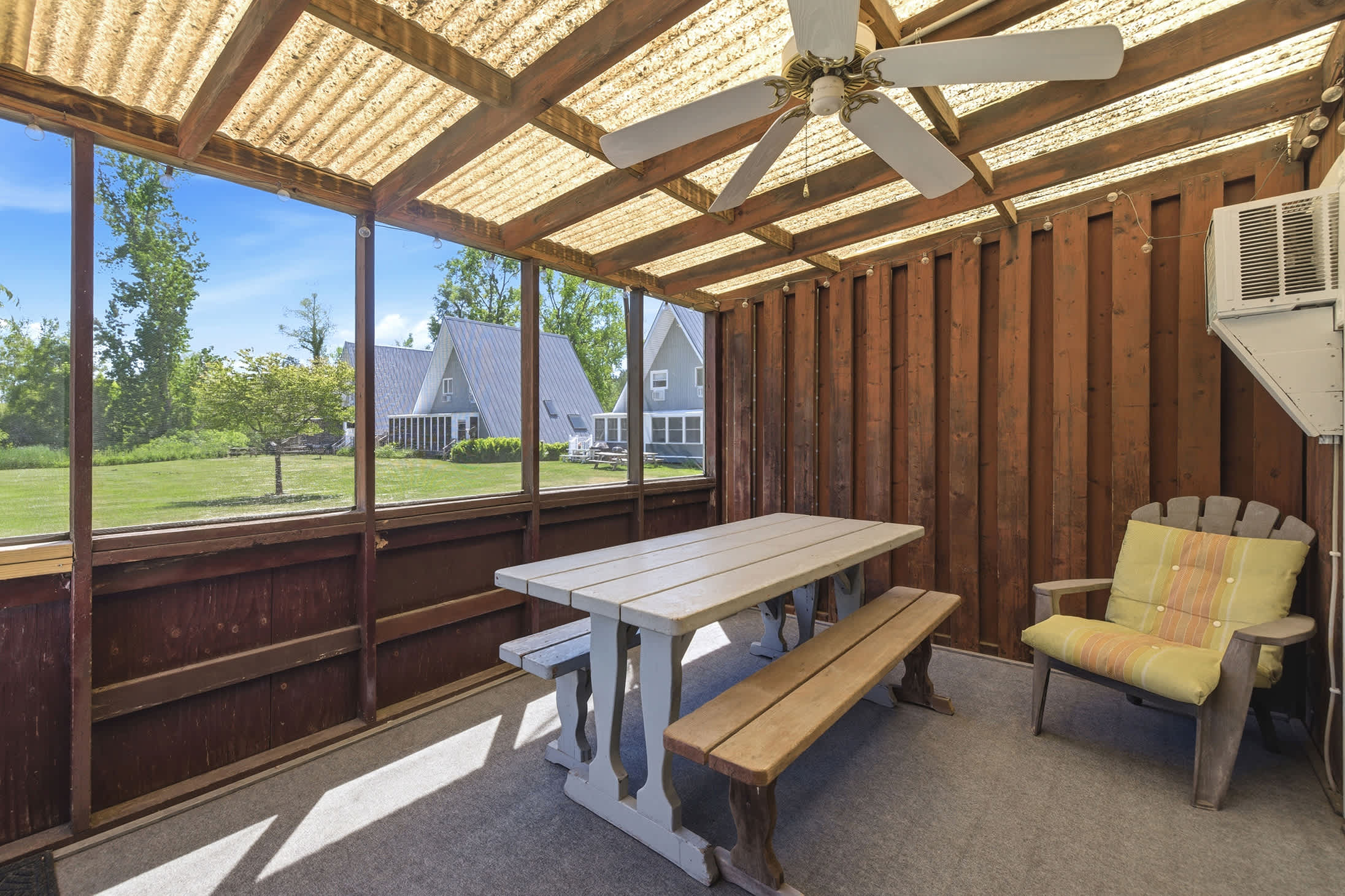 Screened porch with picnic-style seating gives families a comfortable place to gather.