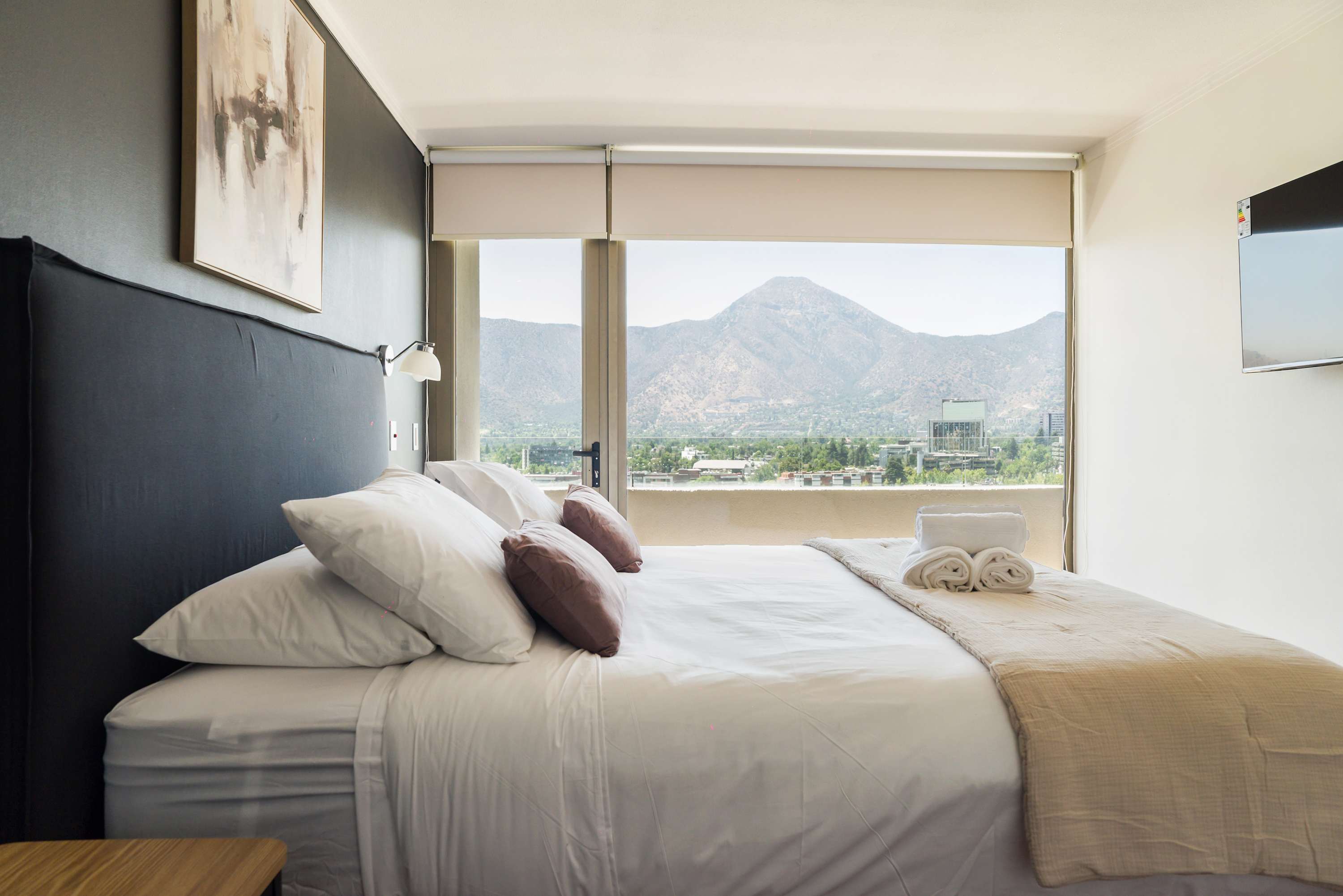 Relax in this cozy bedroom with stunning mountain views and modern amenities, perfect for unwinding after a day of exploring.