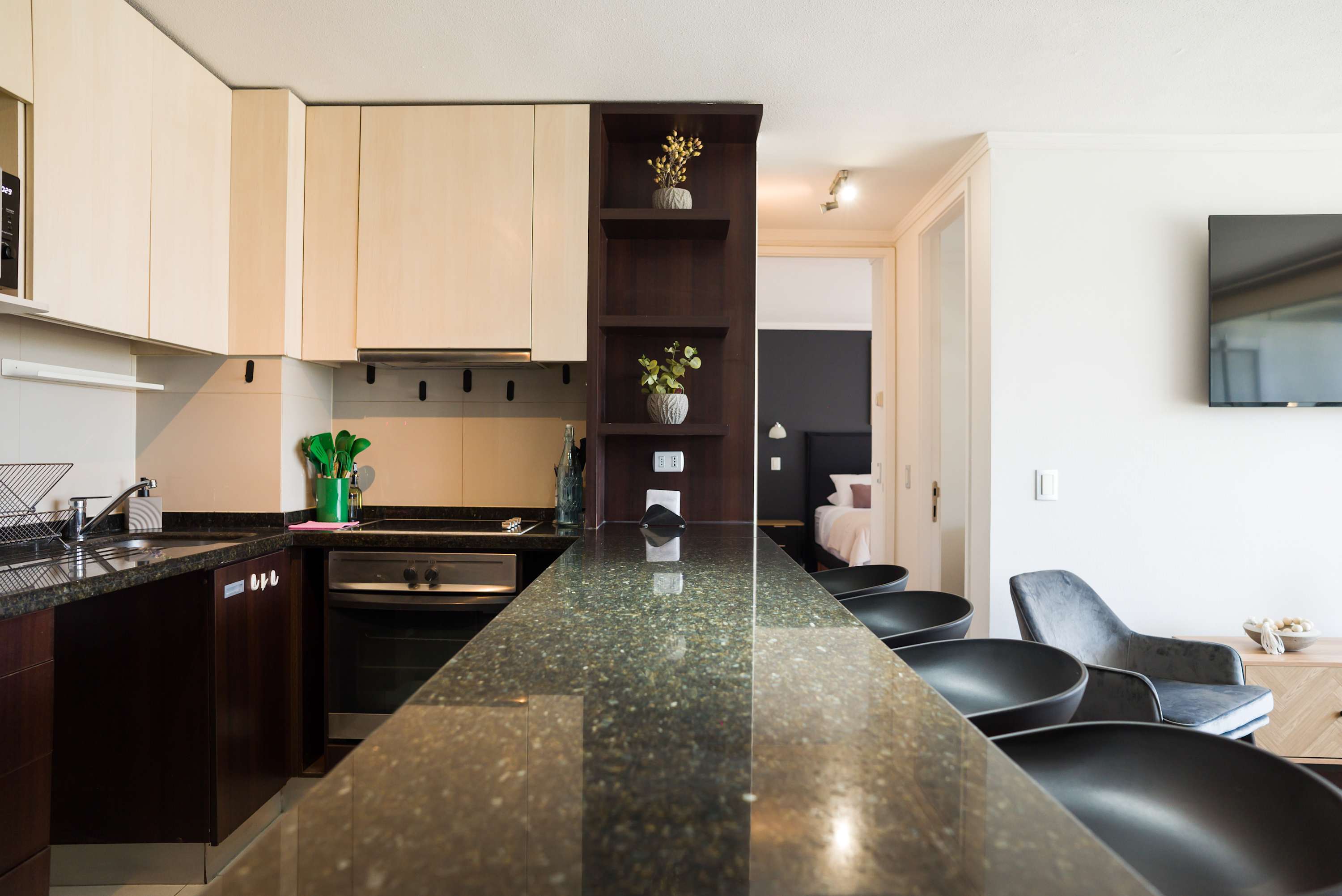 Sleek and modern kitchen with bar seating, perfect for enjoying meals and socializing.