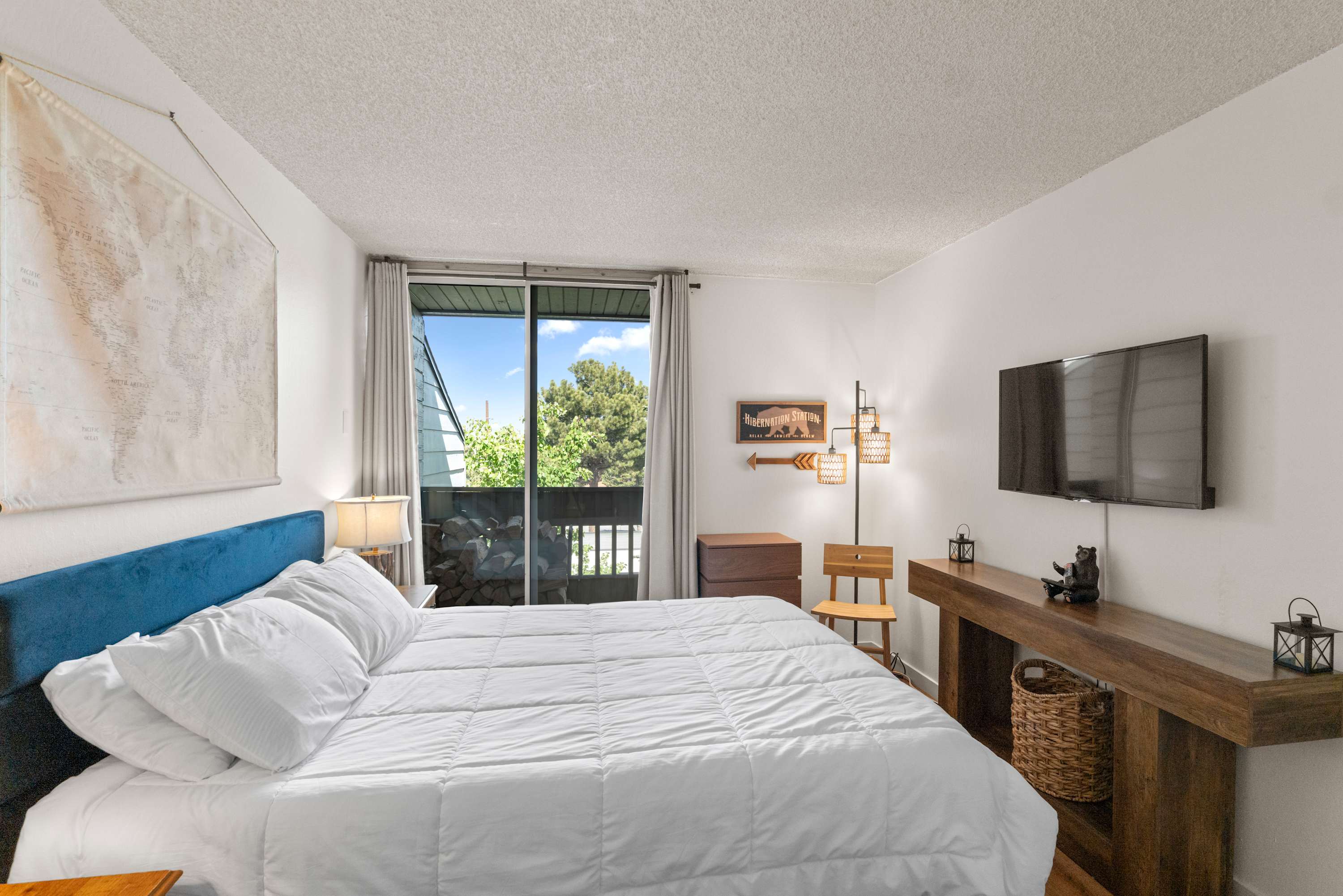 Cozy primary queen bedroom with balcony access
