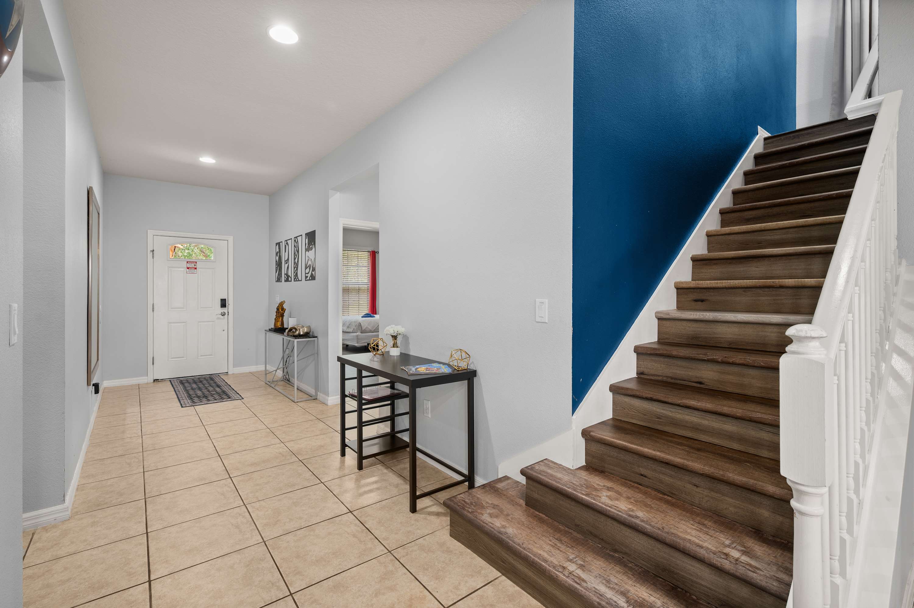 Clean staircase w/ modern railing leading up to the private bedroom suites.