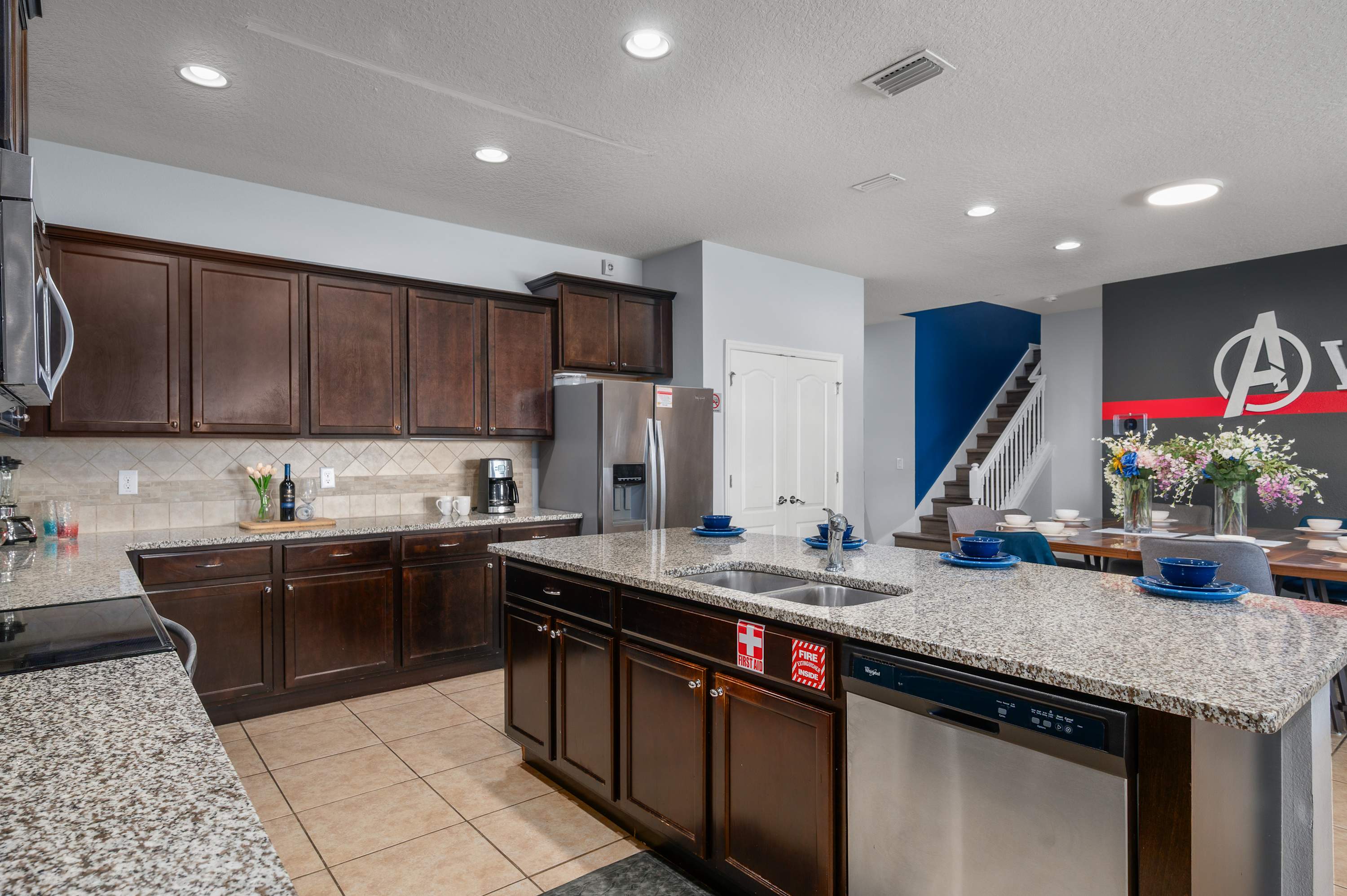 Kitchen detail w/ dark wood cabinets & sink area — well-equipped for cooking in.