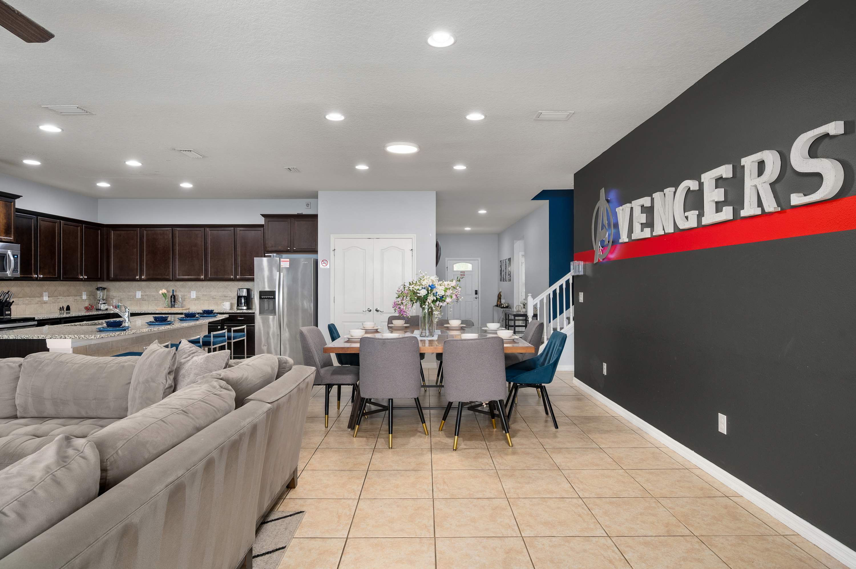 Avengers lounge w/ bold mural & plush seating — a cool hangout spot for the whole family.