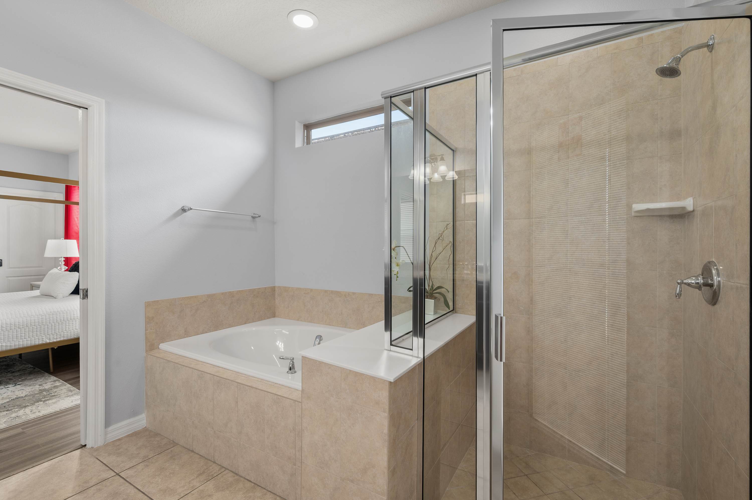 Bathroom w/ separate soaking tub & glass-enclosed shower — a relaxing end to any day.