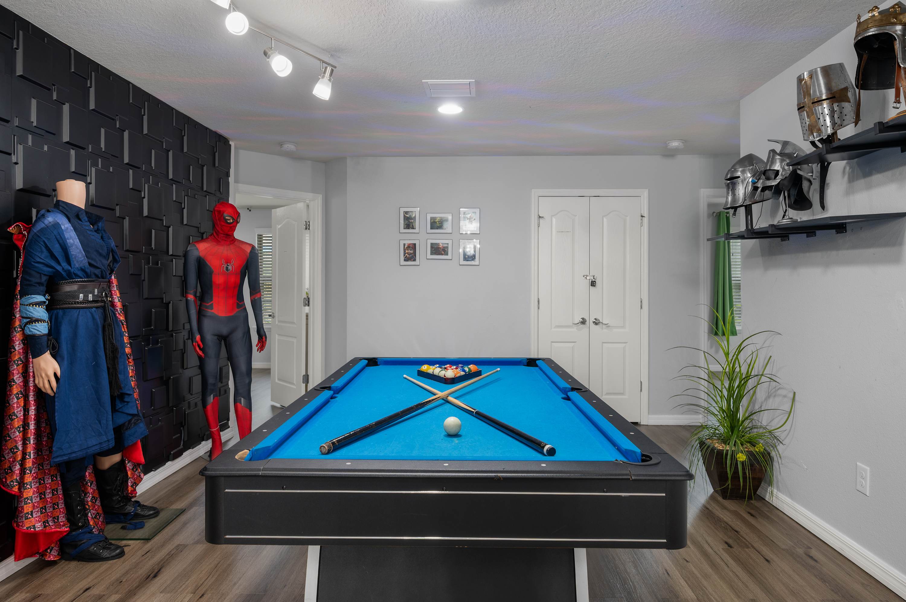 Avengers-themed game room w/ pool table & costume display for the ultimate fan experience.