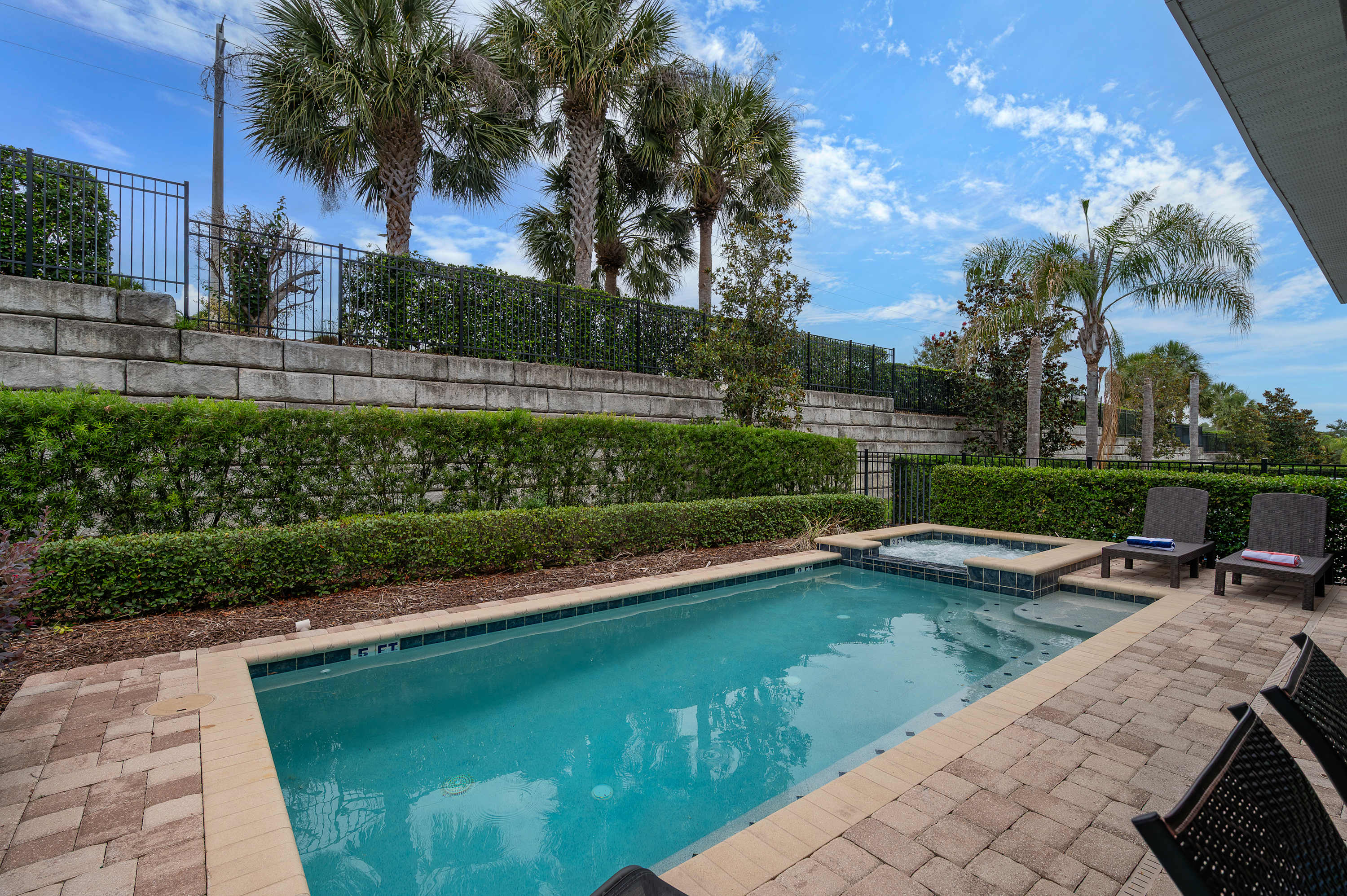 Relax by the pool and spa surrounded by tropical landscaping for a peaceful retreat.