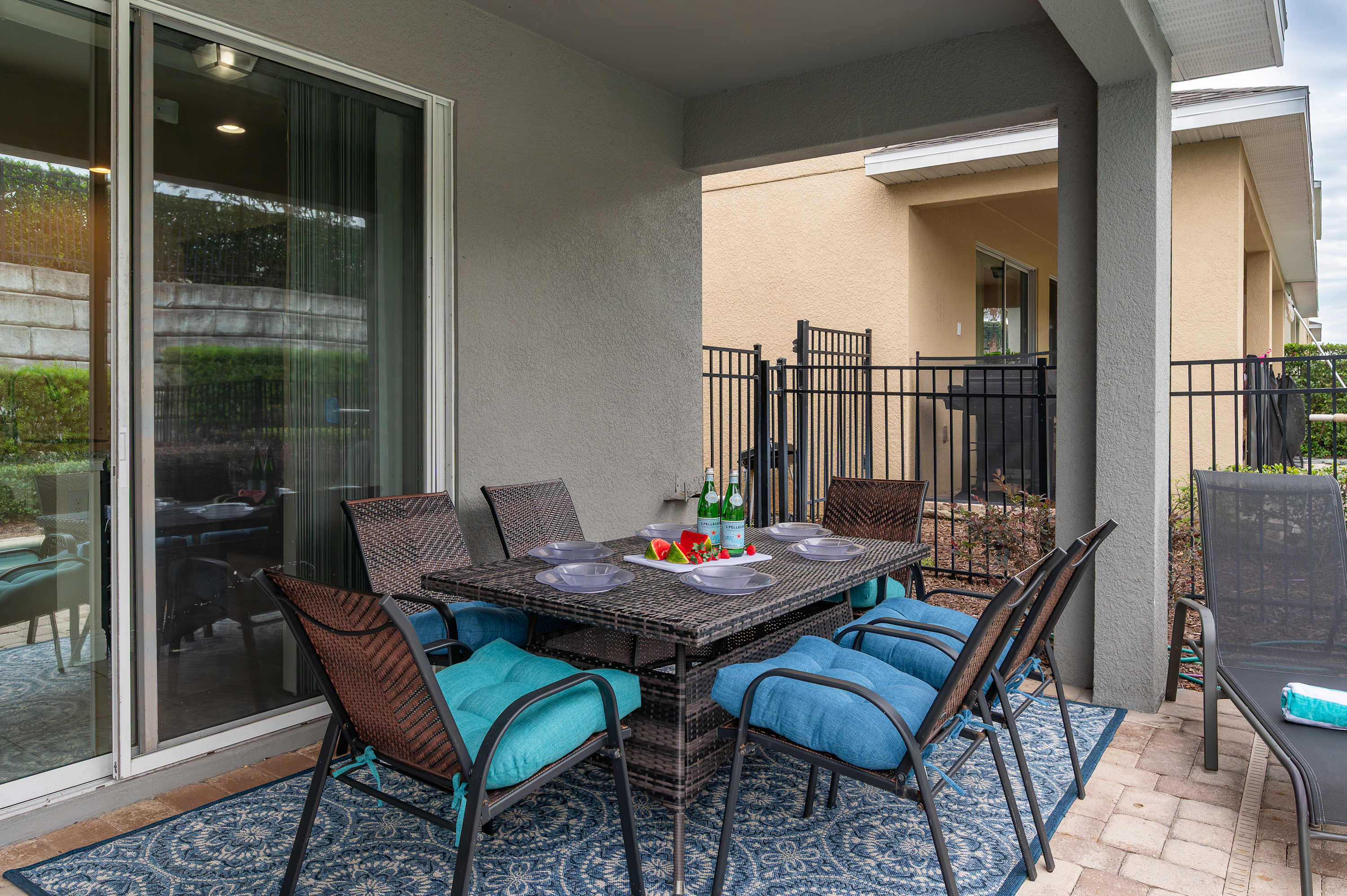 Covered patio with a dining table and cushioned chairs for outdoor meals.