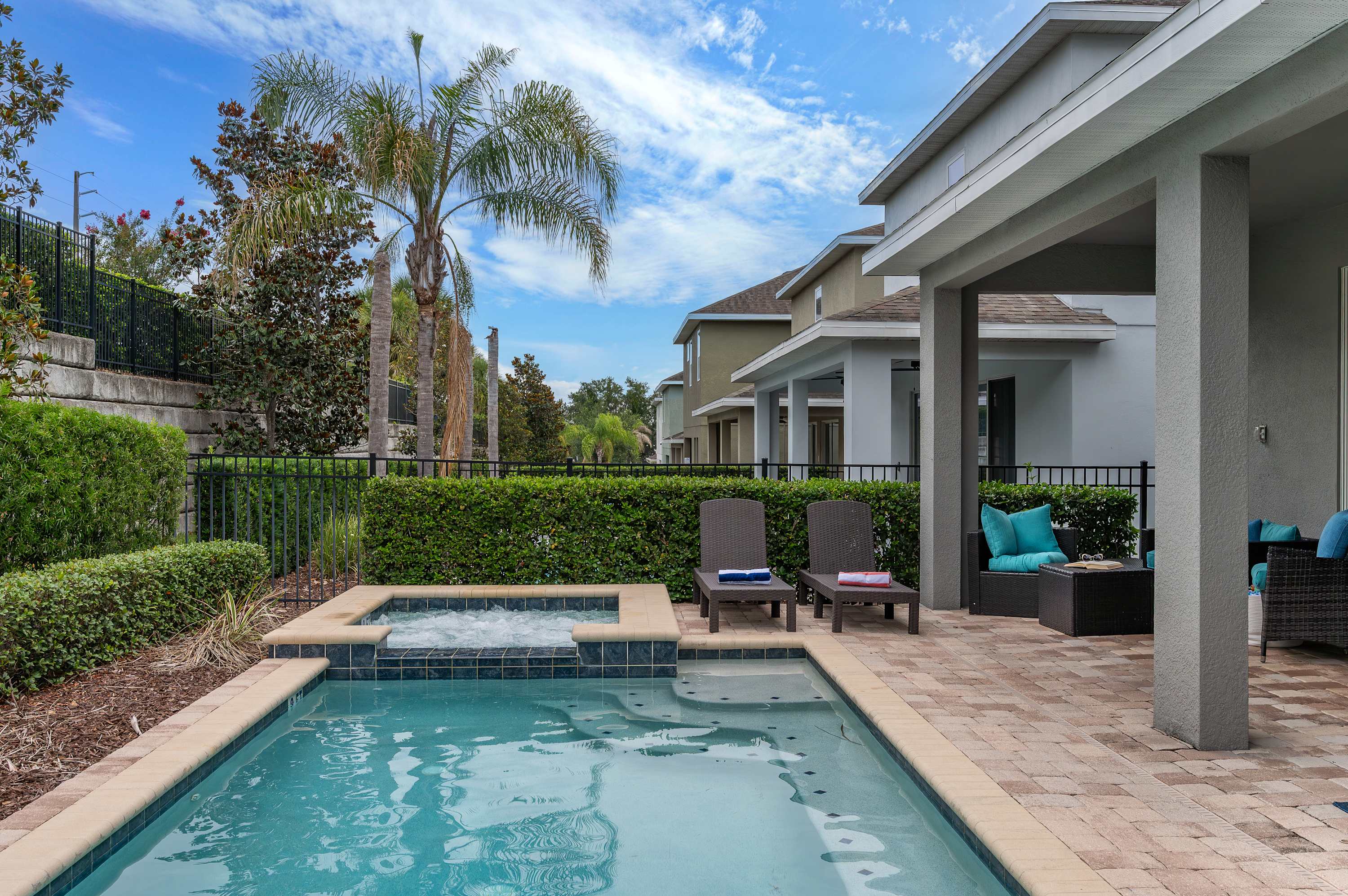 Relax by the pool and spa in this modern outdoor patio area.