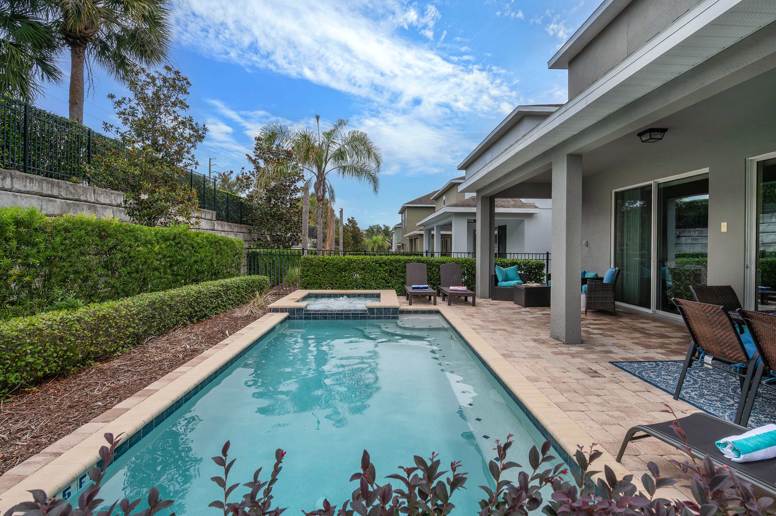 Relax by the private pool and spa in this modern outdoor patio area.