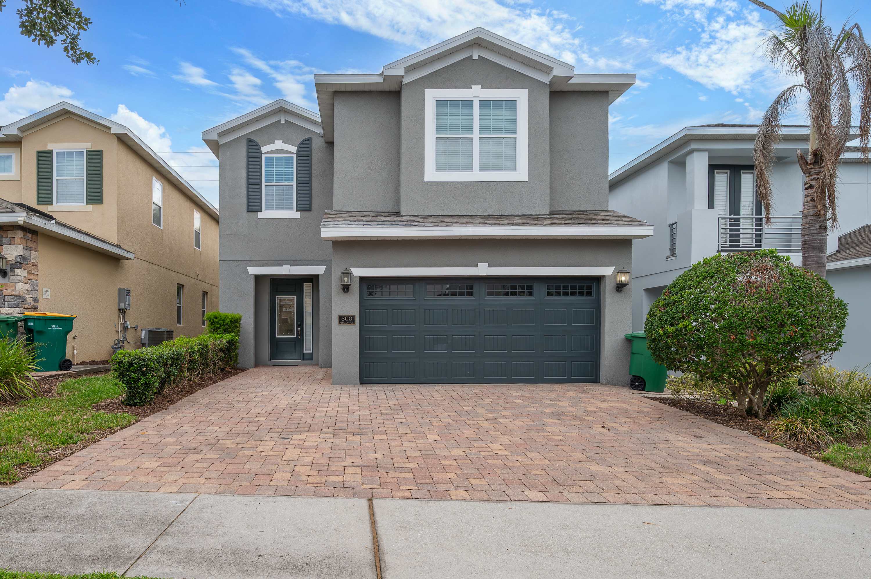 Modern two-story home with a spacious driveway and attached garage.